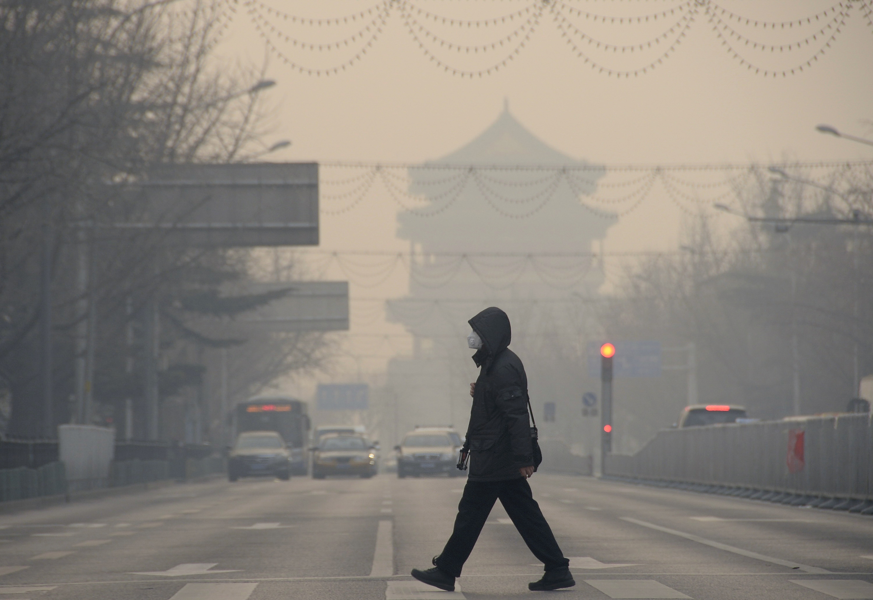 A pedestrian walks amid heavy smog in Beijing, capital of China, Dec. 29, 2015. A blue alert for heavy air pollution was issued by Beijing municipal emergency response headquarters. (Xinhua News Agency&mdash;Getty Images)