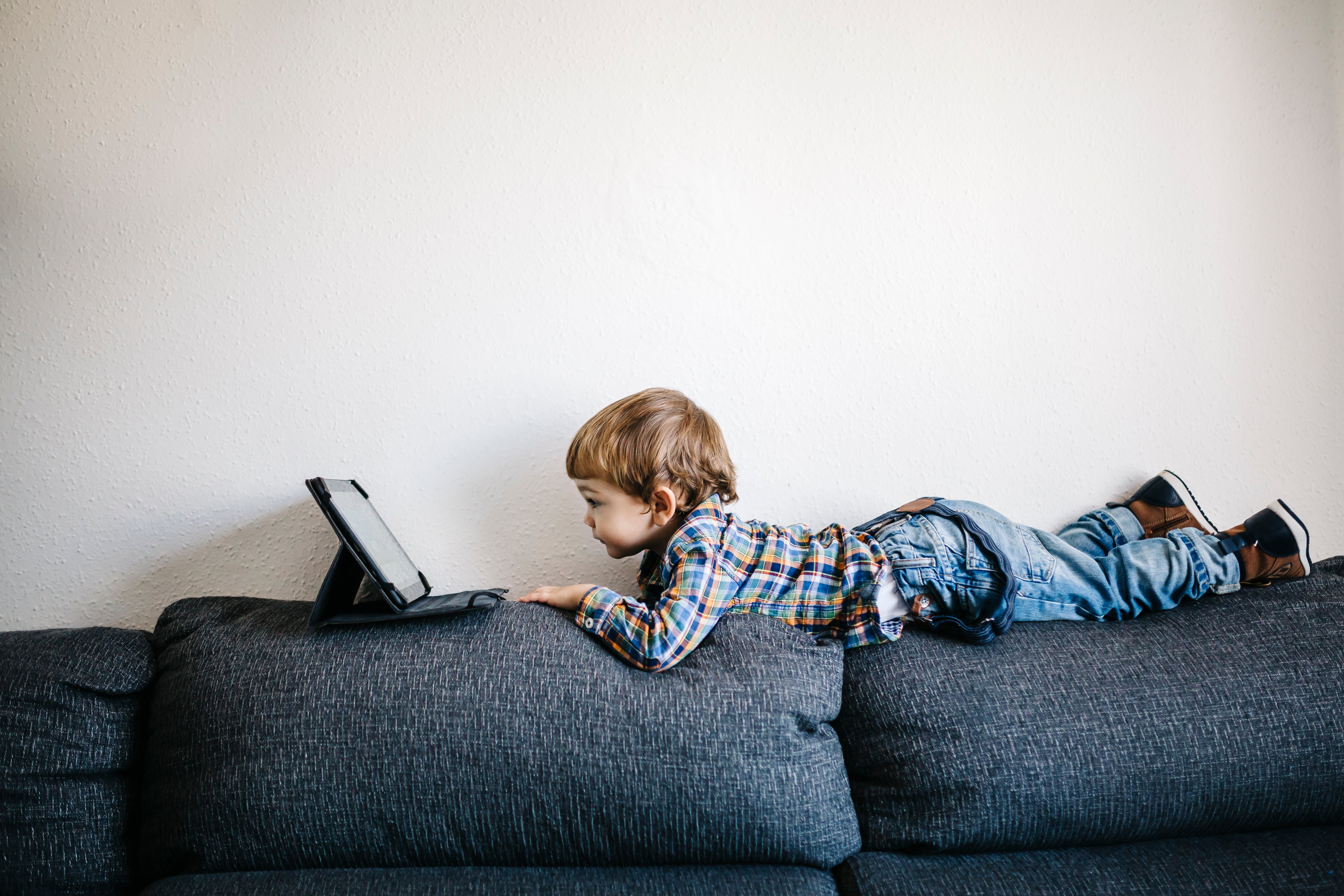boy-watching-tablet-couch