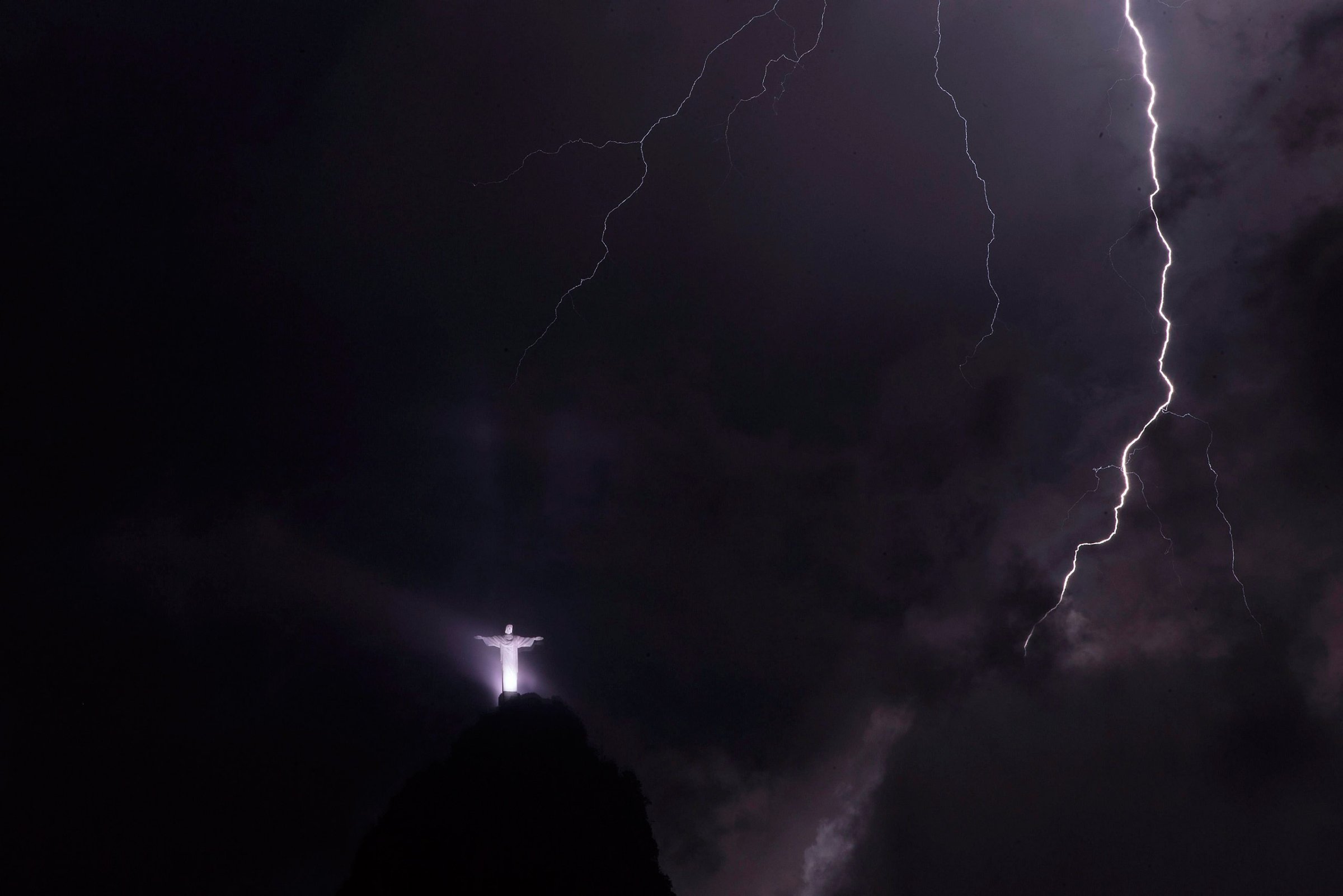 Lightning strikes near The Christ the Redeemer statue atop of Corcovado Mountain during a storm in Rio de Janeiro, Brazil, Feb. 23, 2016.