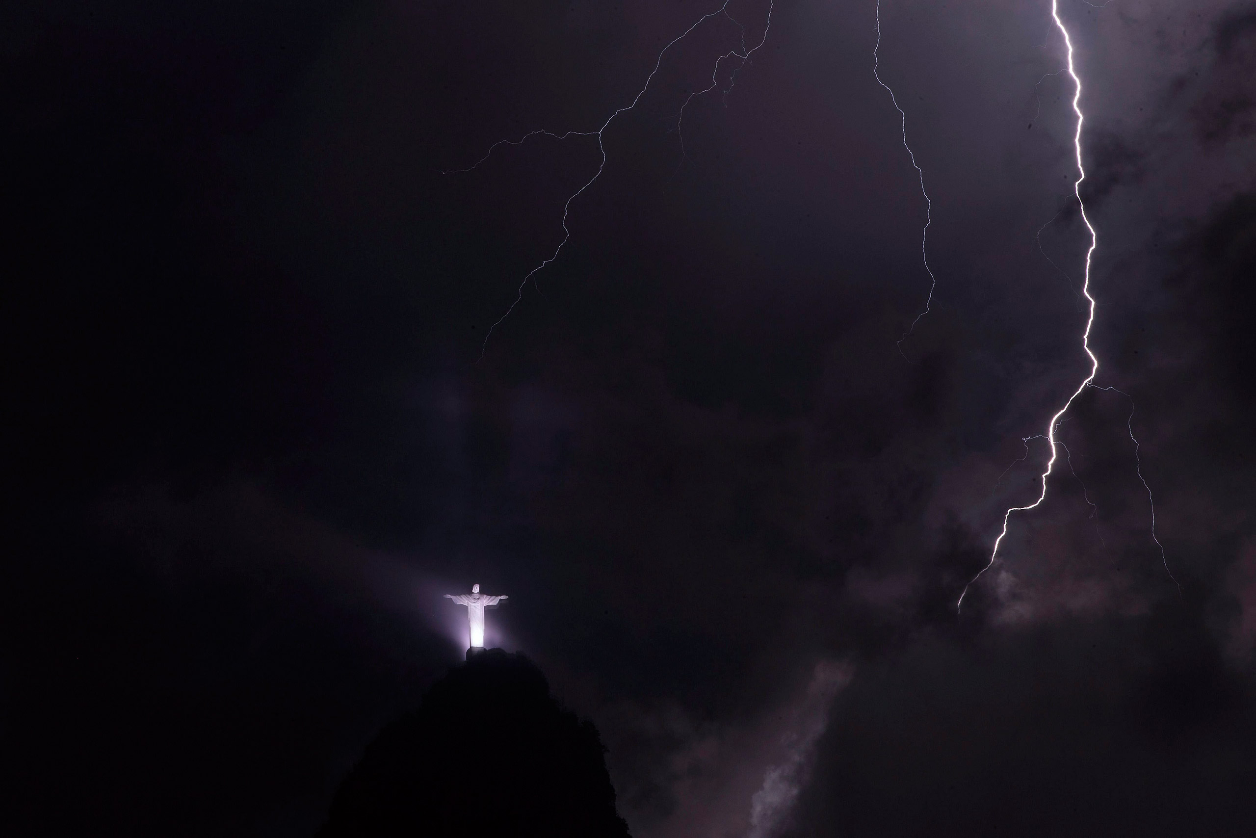 Lightning strikes near The Christ the Redeemer statue atop of Corcovado Mountain during a storm in Rio de Janeiro, Brazil, Feb. 23, 2016. (Marcelo Sayao—EPA)