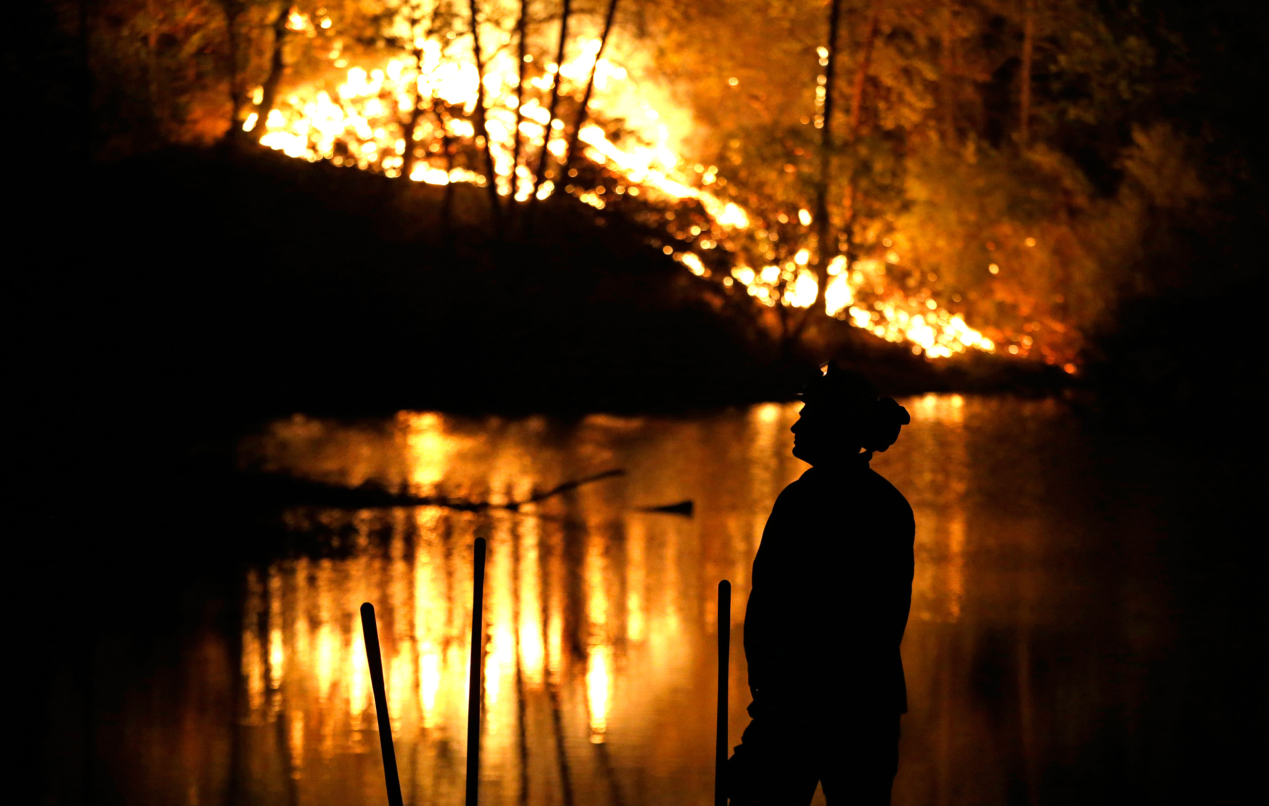 A firefighter stands near a wildfire in Middletown, Calif., on Sept. 13, 2015. (Elaine Thompson—AP)