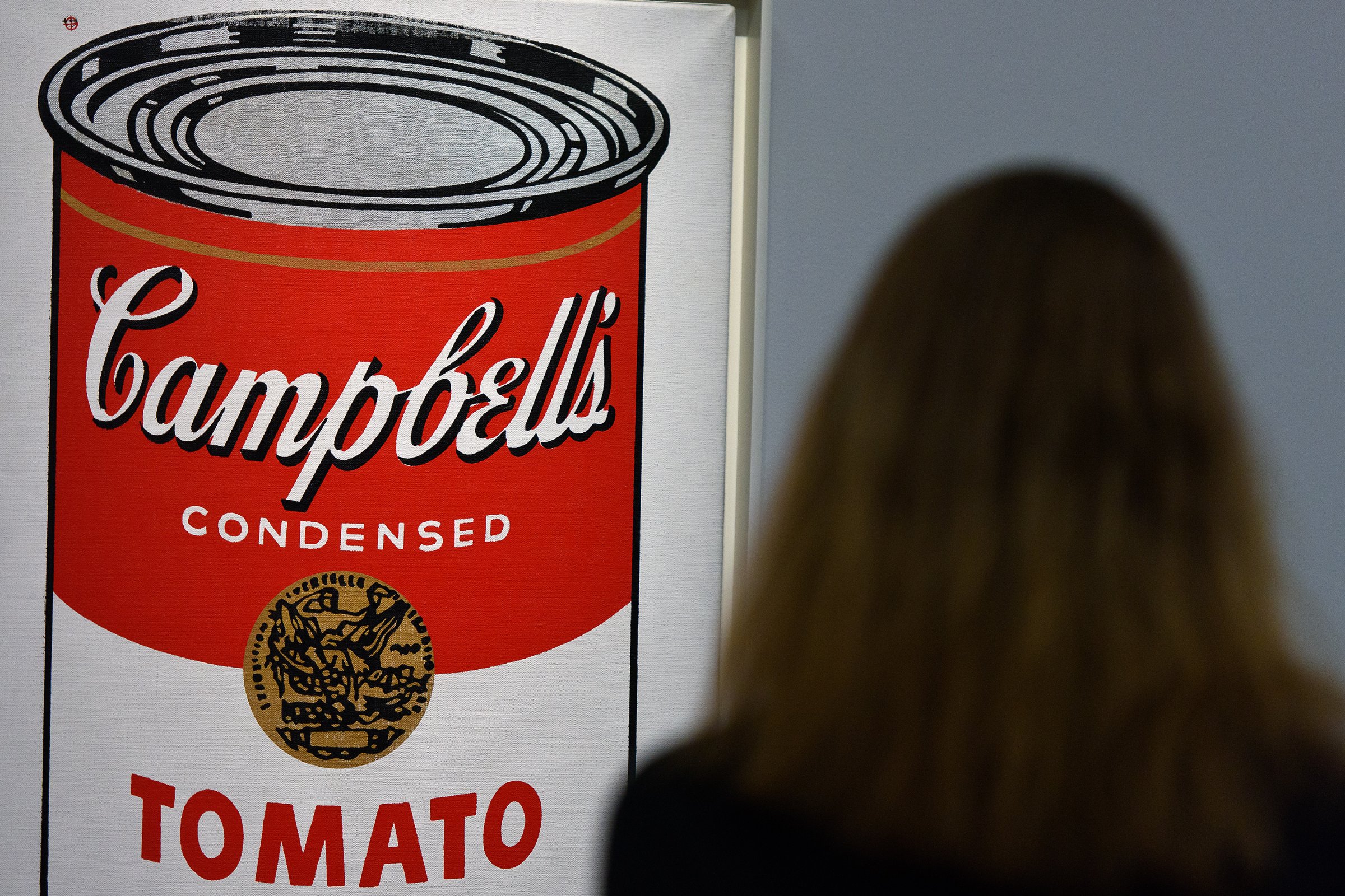 A guest views Large Campbell's Soup Can by Andy Warhol at Sotheby's Giants Of 20th Century Art Sale in London on Jan. 28, 2016.