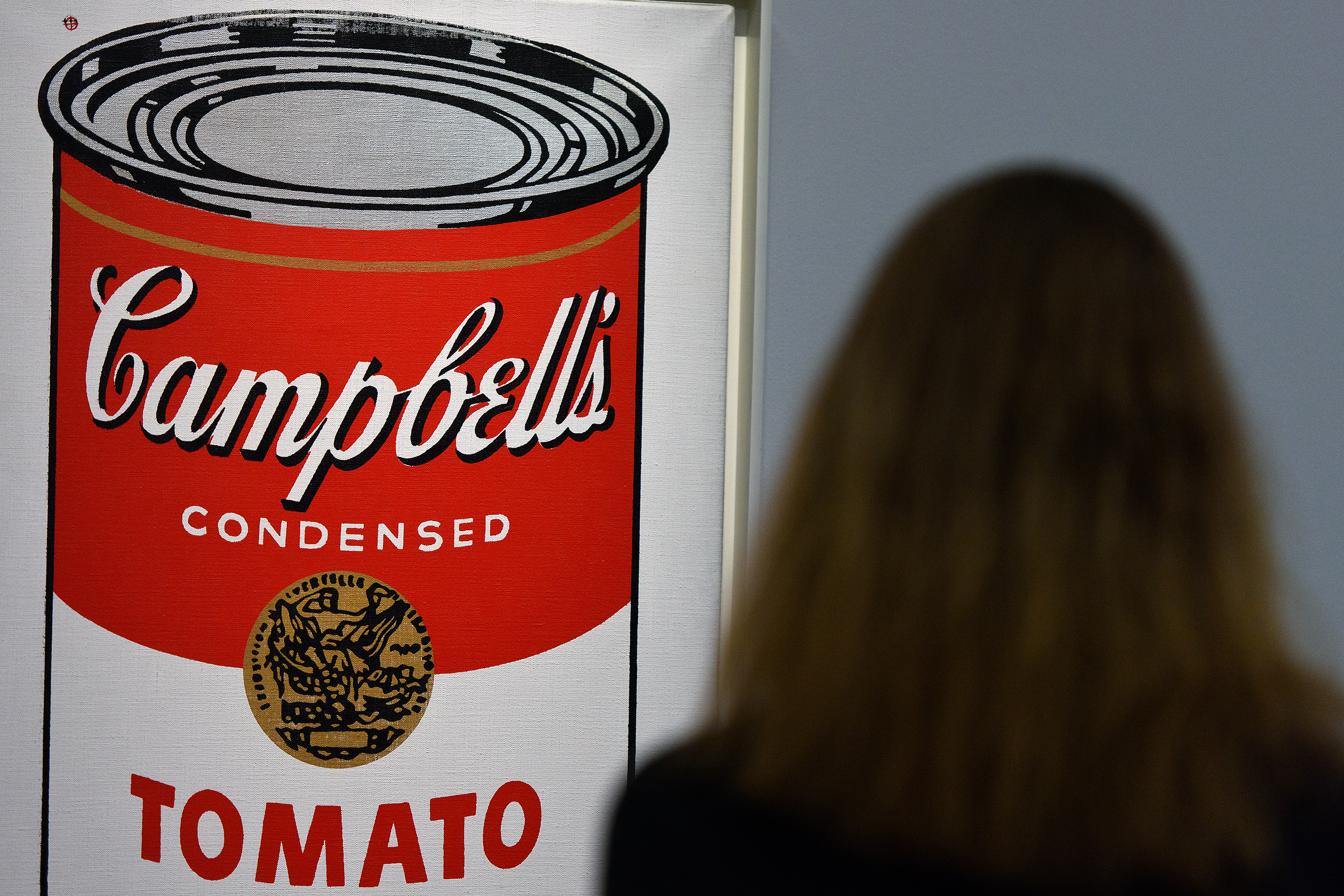 A guest views Large Campbell's Soup Can by Andy Warhol at Sotheby's Giants Of 20th Century Art Sale in London on Jan. 28, 2016. (Ben Pruchnie—Getty Images)