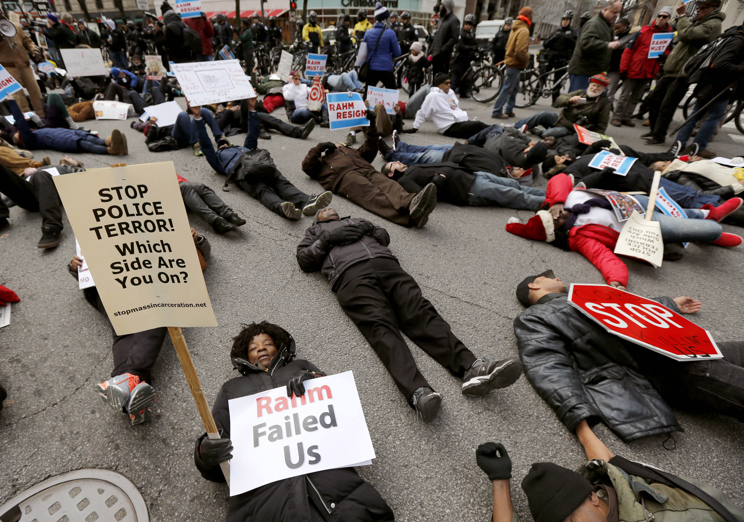 Protesters block an intersection on the Magnificent Mile, calling for the resignation of Mayor Rahm Emanuel, in Chicago on Dec. 24, 2015. (Charles Rex Arbogast—AP)