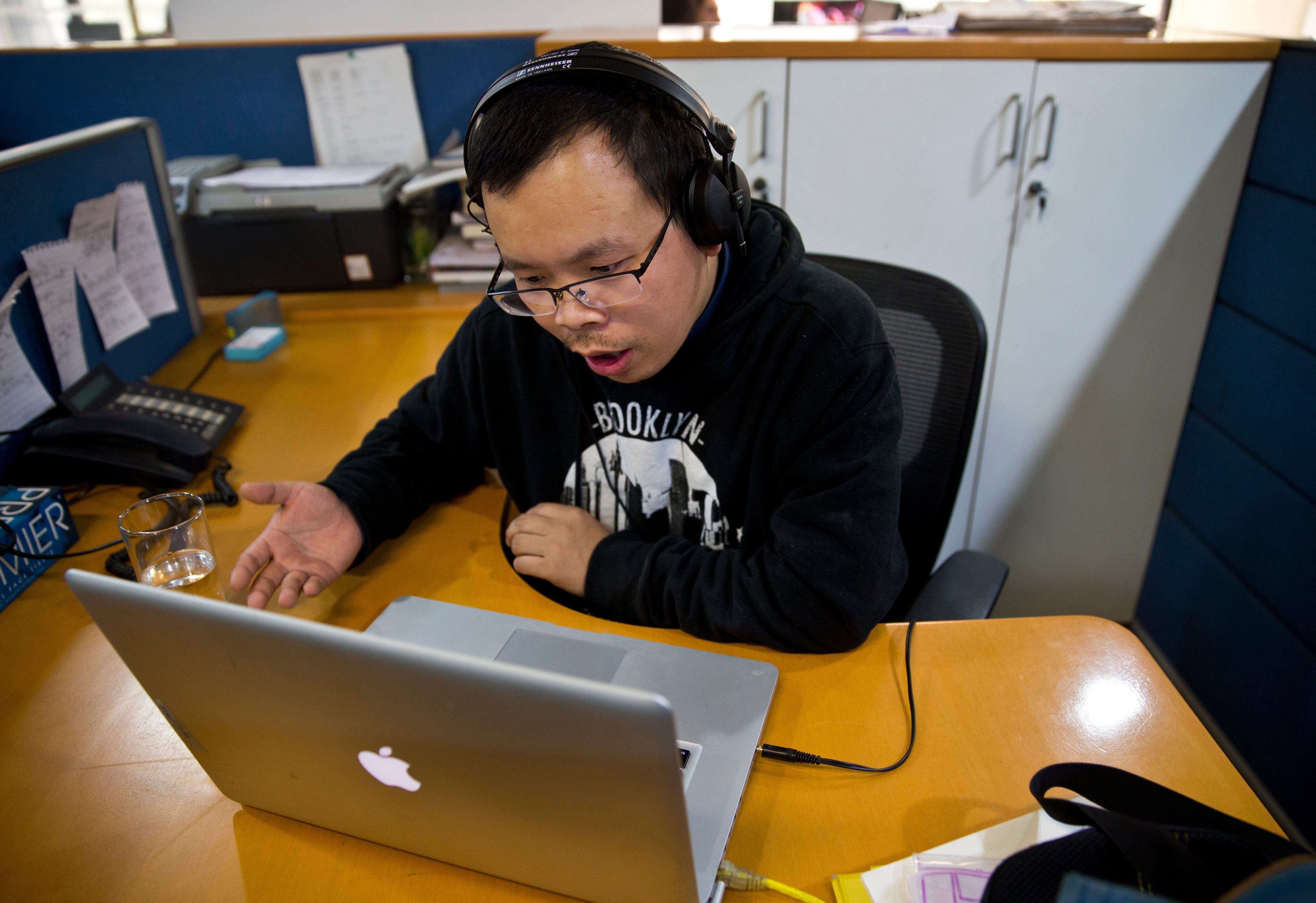 In this Nov. 20, 2015, file photo, Chinese journalist Li Xin talks to an Associated Press reporter over Skype, at the Associated Press office in New Delhi, India (Saurabh Das—AP)