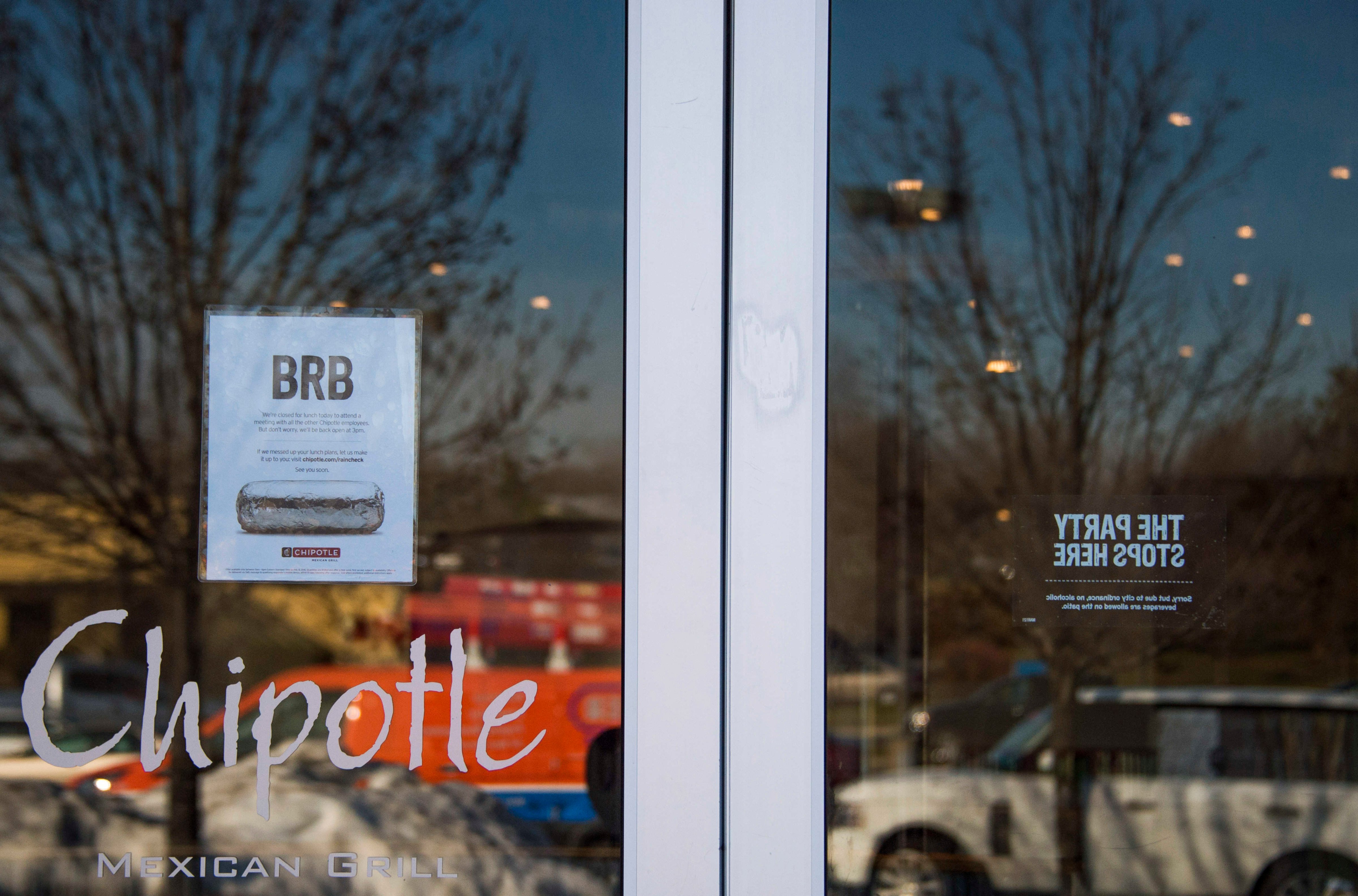 A sign is posted in the window of Chipotle Mexican Grill in Bowie, Maryland, advising customers they will be closed for a company wide meeting on February 8, 2016.