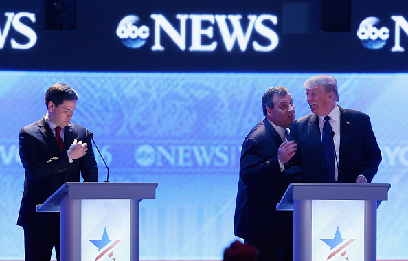 Republican presidential candidates New Jersey Governor Chris Christie (2nd R) and Donald Trump visit as Sen. Marco Rubio (R-FL) (L) stands close by during a commercial break in the Republican presidential debate at St. Anselm College February 6, 2016 in Manchester, New Hampshire.