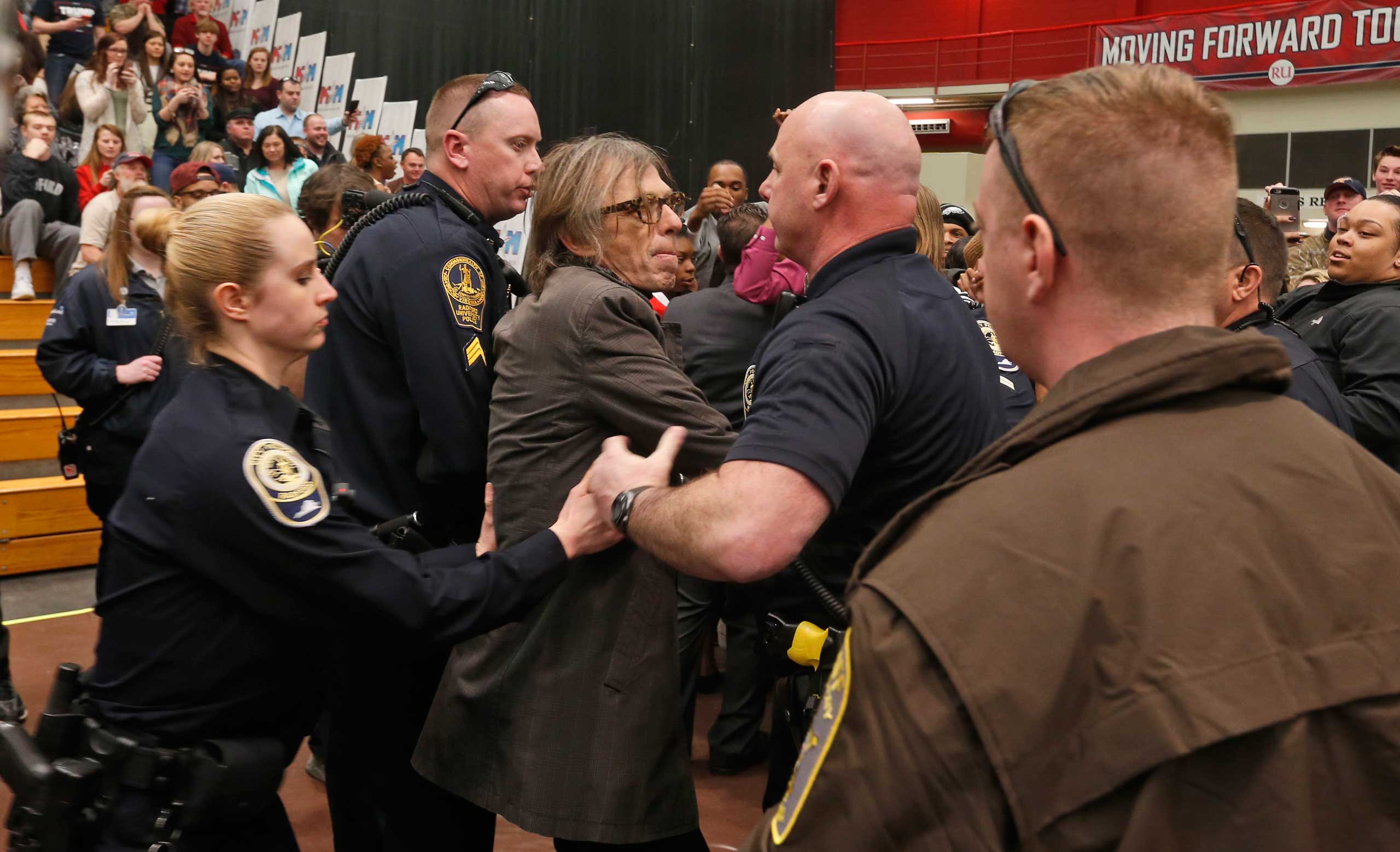TIME photographer Christopher Morris is detained by police during a rally of Republican presidential candidate, Donald Trump, at Radford University in Radford, Va., Feb. 29, 2016. (Steve Helber—AP)