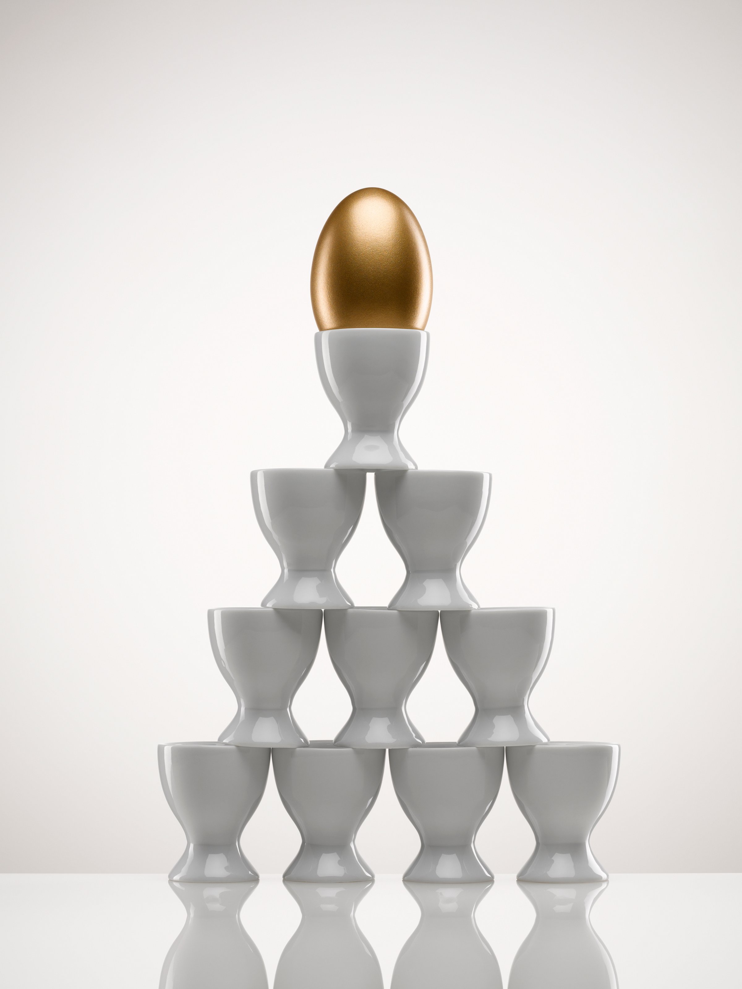 Stacked egg cups with golden egg