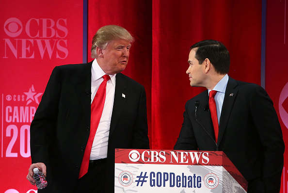 Republican presidential candidates Sen. Marco Rubio (R-FL) (R) listens to Donald Trump (L) during a break of a CBS News GOP Debate February 13, 2016 at the Peace Center in Greenville, South Carolina.