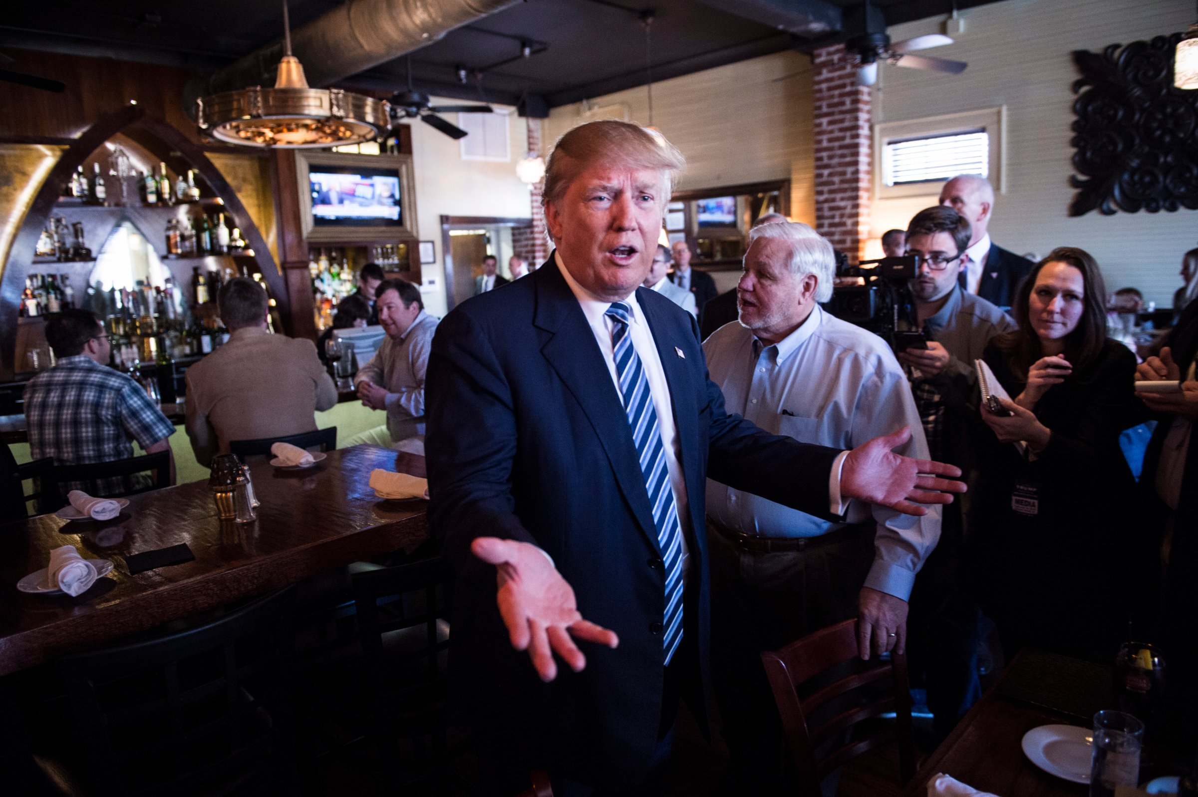 Republican presidential candidate Donald Trump greets people while making a stop for lunch between campaign events at Fratello's Italian Tavern in North Charleston, S.C. on Feb. 18, 2016.