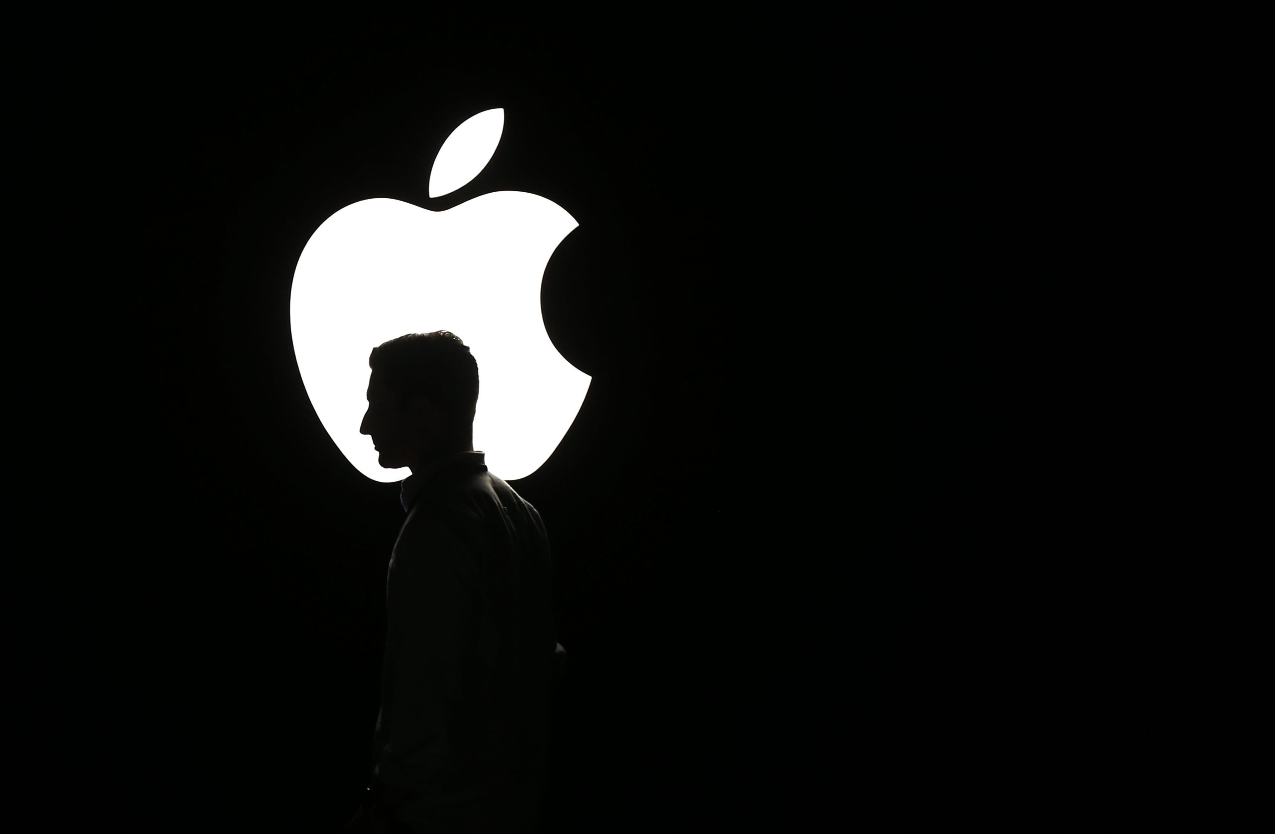 A man walks in front of the Apple logo during a product announcement event from the Bill Graham Civic Auditorium in San Francisco, Sept. 9, 2015. (Monica Davey—EPA)