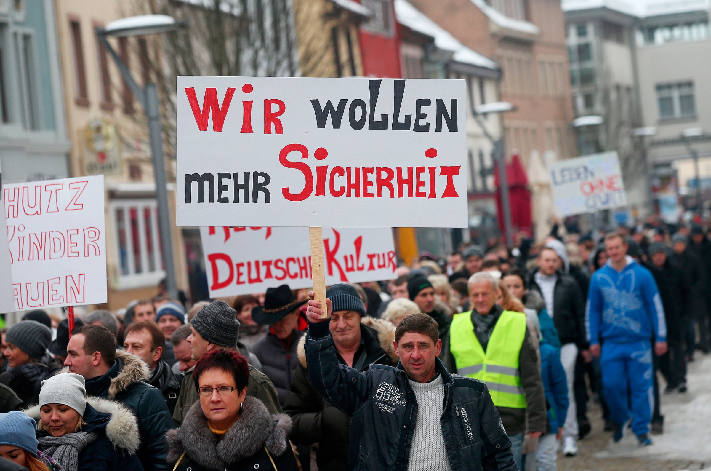 Hundreds of Russlanddeutsche, or ethnic Germans who had formerly lived in Russia, demonstrate with signs reading "we want more security" and against violence in Villingen-Schwenningen, Germany, Jan. 24, 2016. The demonstration took place in connection with the alleged rape of a 13-year-old girl by a refugee, which the police say did not happen.