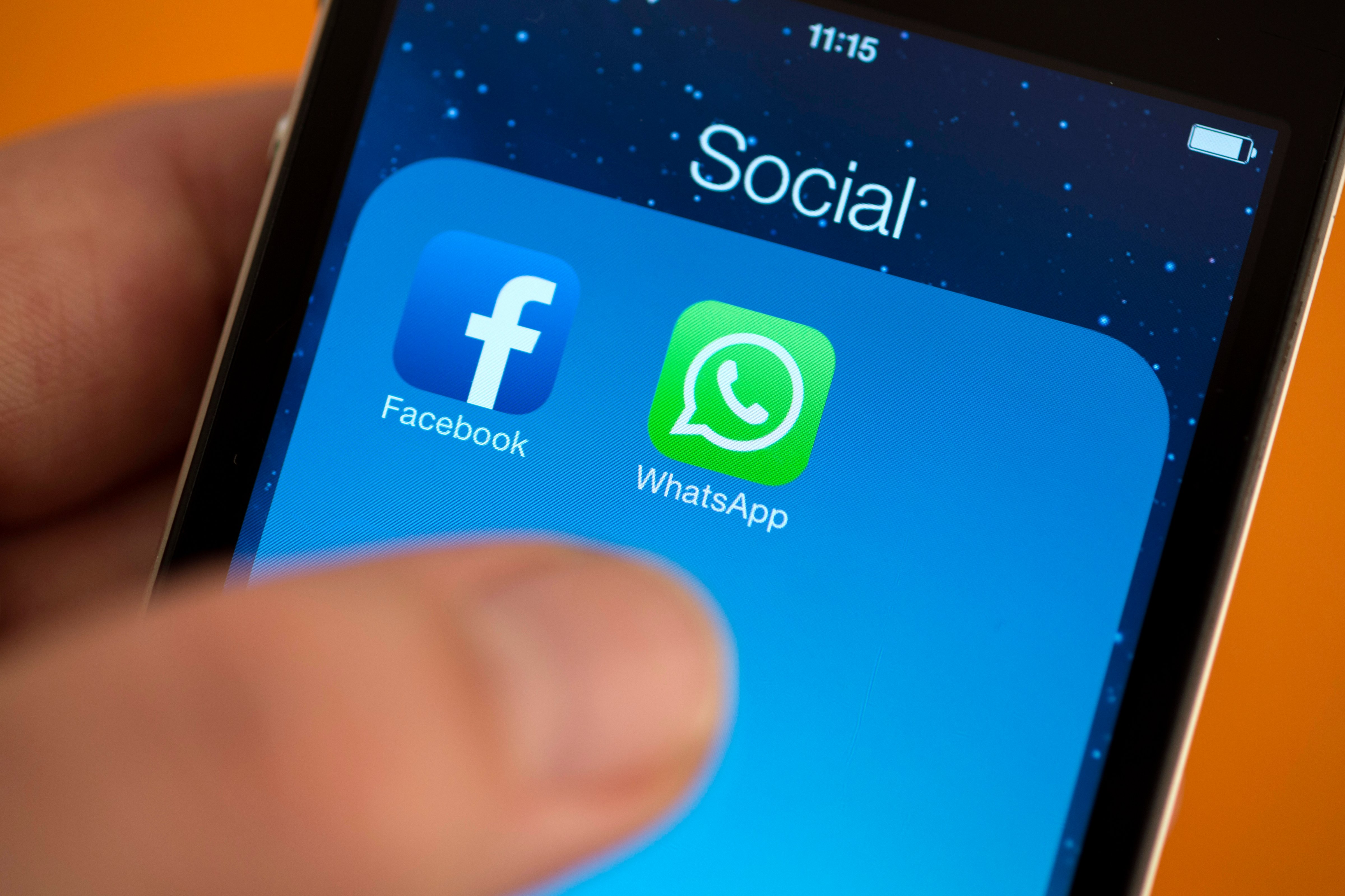 Facebook next to the WhatsApp logo on iPhone hold by a hand. on February 25, 2014 in Berlin, Germany. (Marie Waldmann&mdash;Photothek via Getty Images)