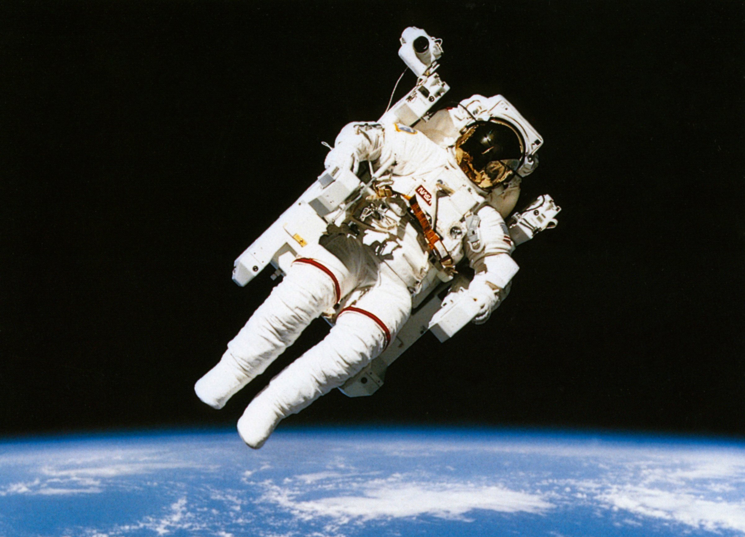 Astronaut floating in orbit above the earth during spacewalk