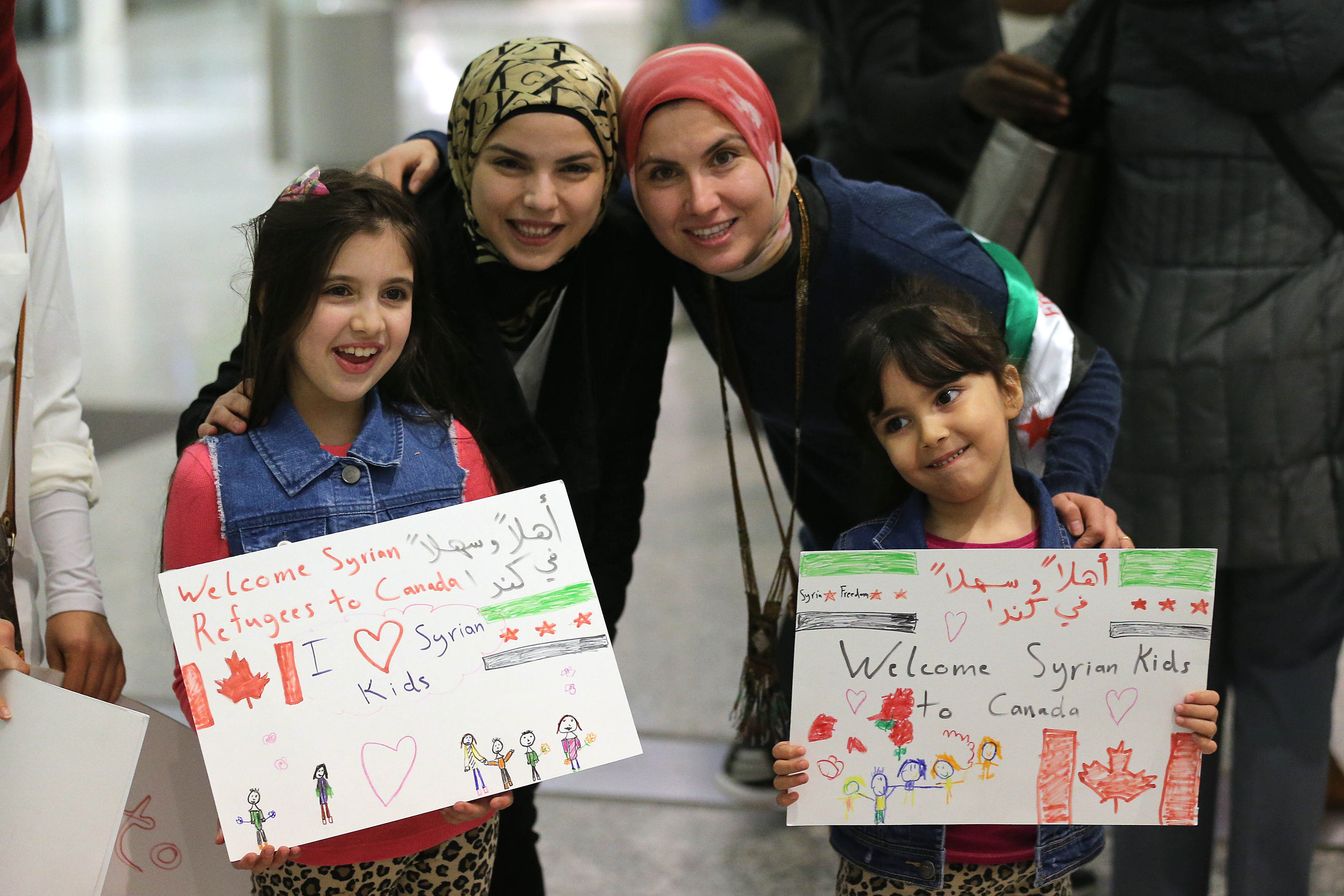 Maryam and Nore Kasmeih wait for Syrian refugees at the airport on Dec. 10, 2015. Their mother came to Canada 15 years ago and their family that was in Syria fled to Turkey. (Steve Russell—Toronto Star/Getty Images)