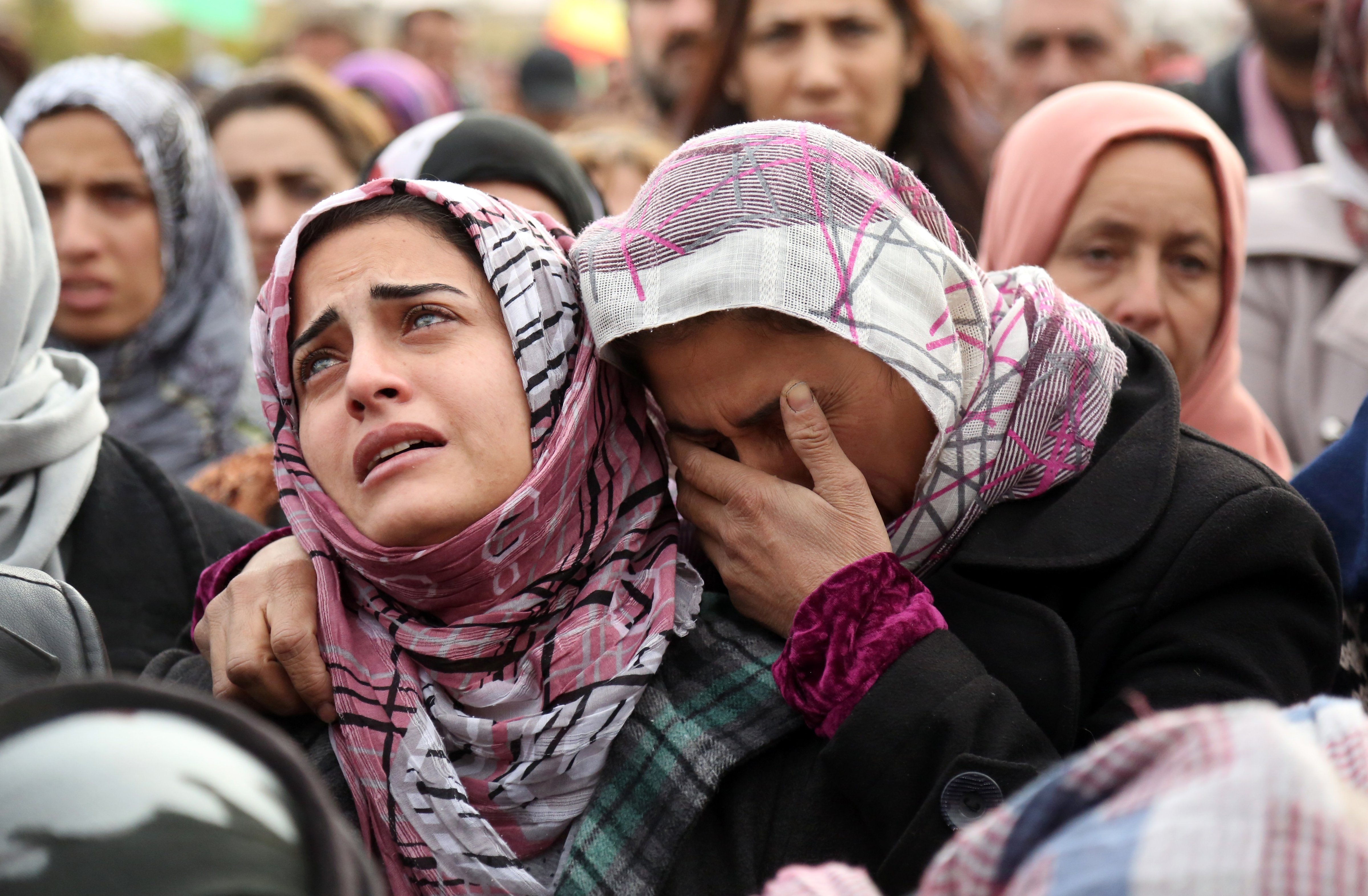 The sister, left, of Mohammed Ismael, who died in a suicide car bombing claimed by the Islamic State of Iraq and Greater Syria, mourns during his funeral in Syria's Hasakeh province on Dec. 13, 2015 (Delil Souleiman—Getty Images)