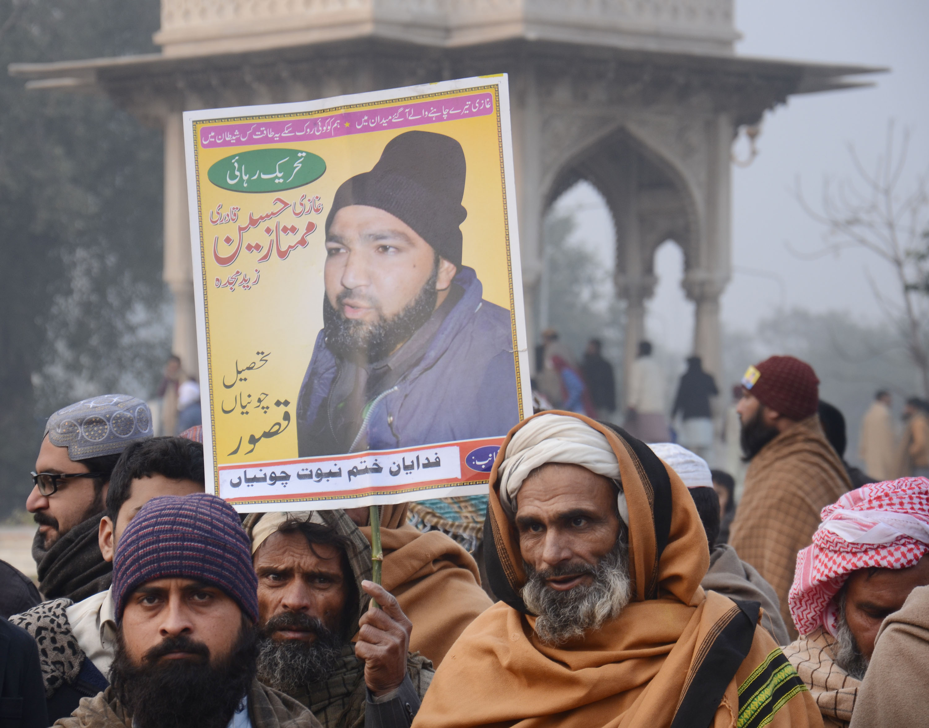 Man holding placard joins the rally in Lahore. Pakistani