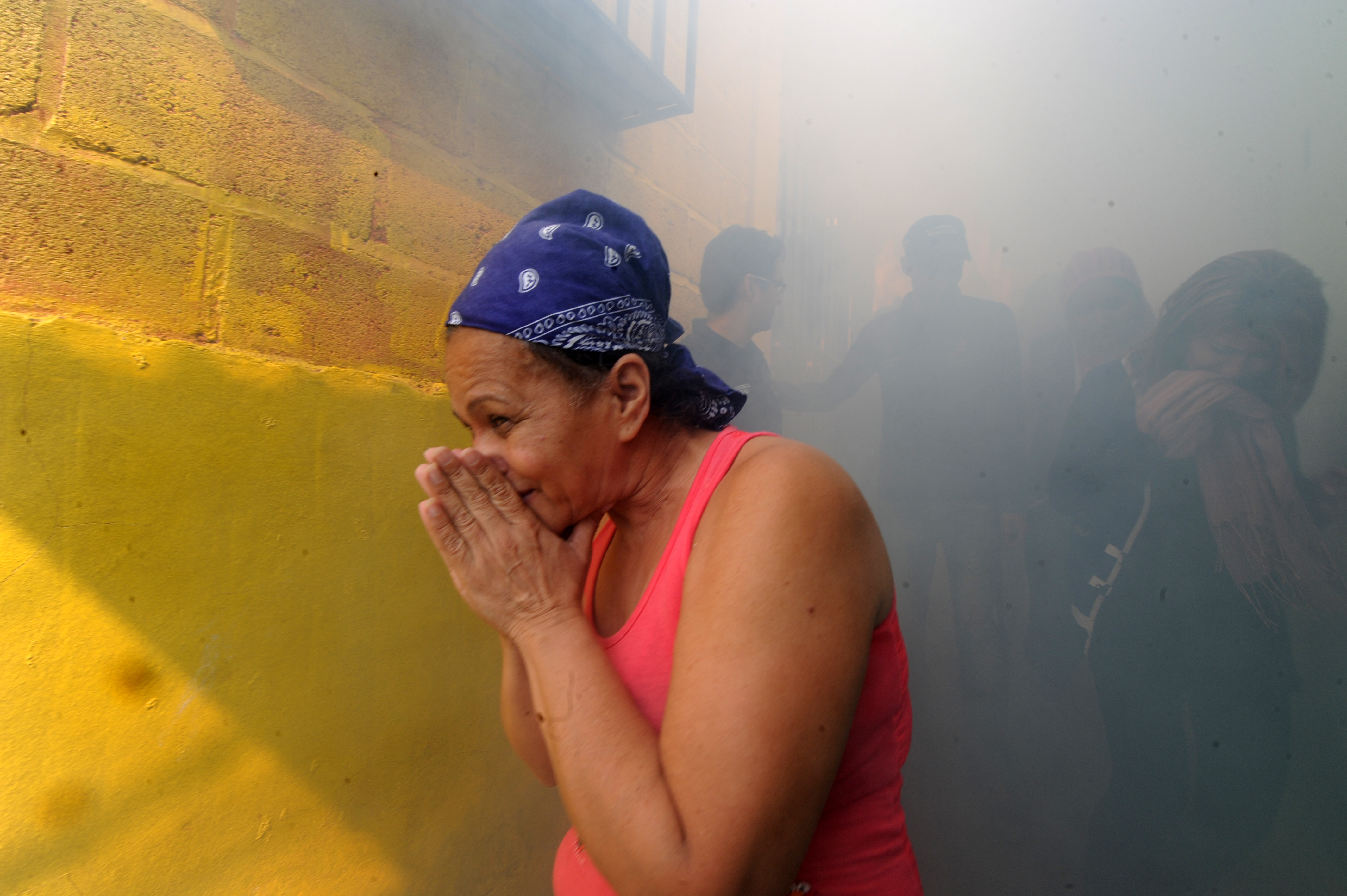 People help soldiers fumigate in the fight against Aedes Aegypti mosquito that transmits Zika virus, in Tegucigalpa on February 6, 2016. (Orlando Sierra—AFP/Getty Images)