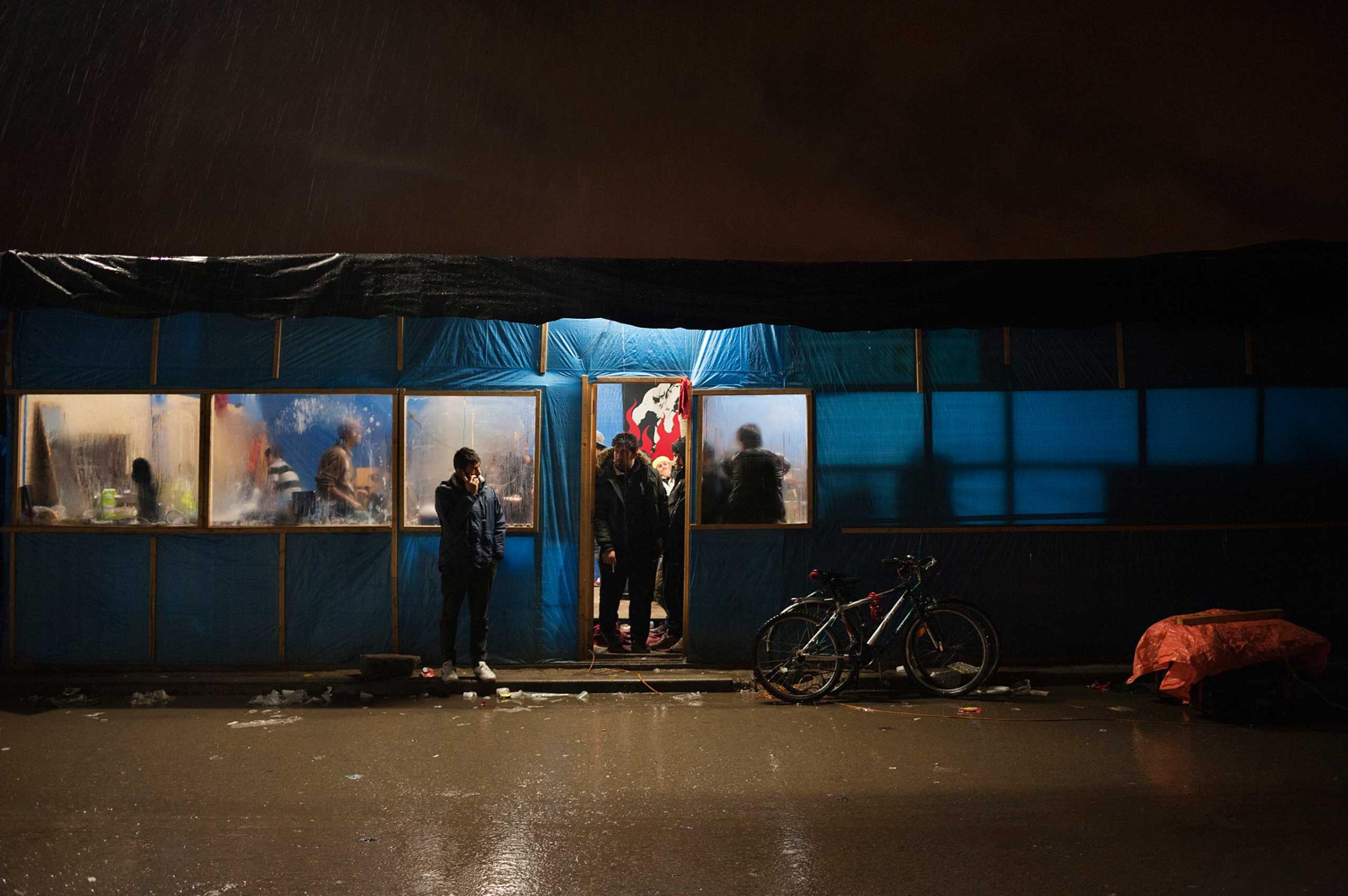 Sheltering from the rain in an Afghan restaurant in Calais, France on Nov. 4, 2015.
