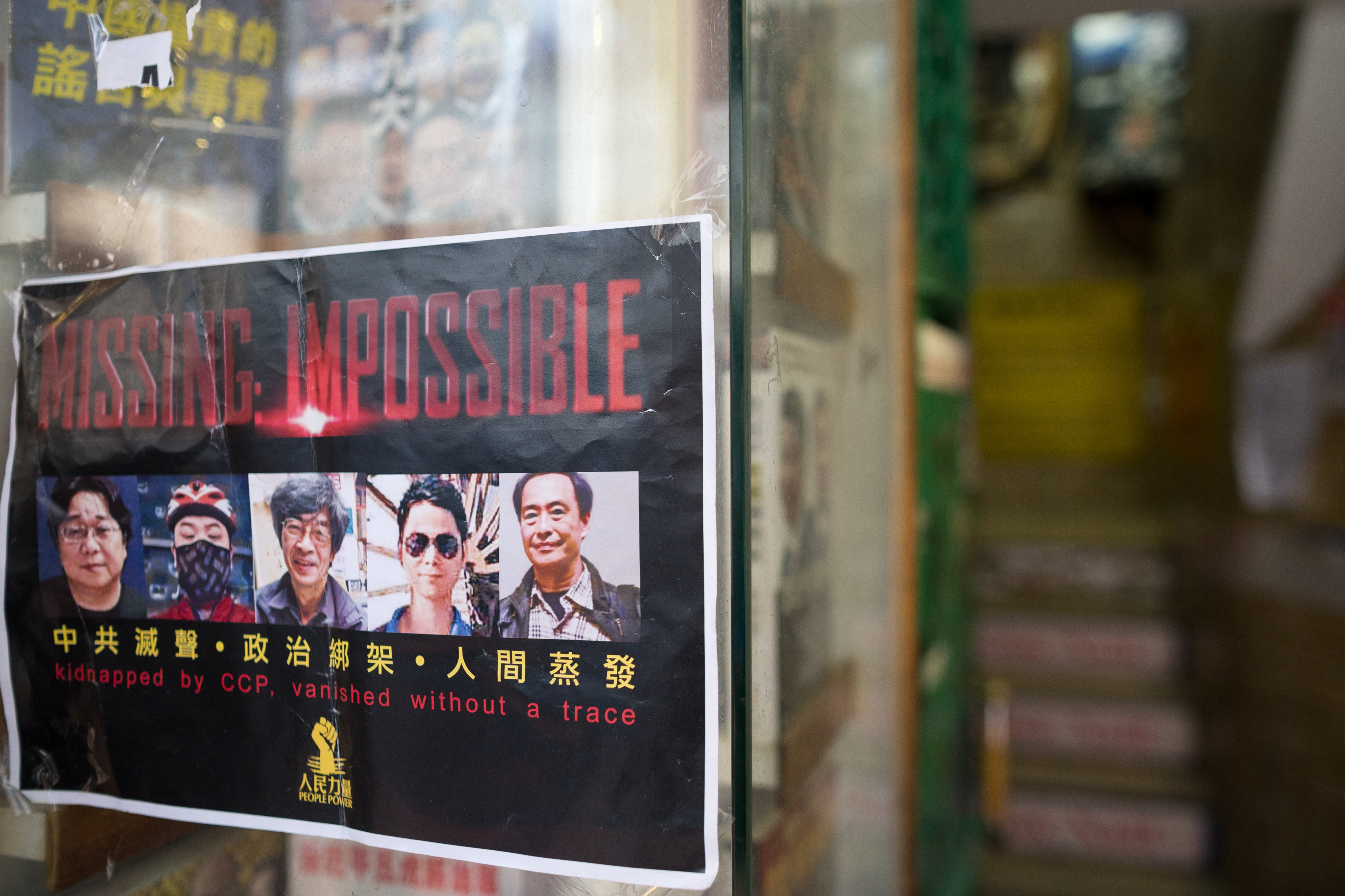 A flyer with photos of five Hong Kong booksellers hangs on the entrance to Causeway Bay Books shop in Hong Kong on Feb. 5, 2016 (Jerome Favre—EPA)