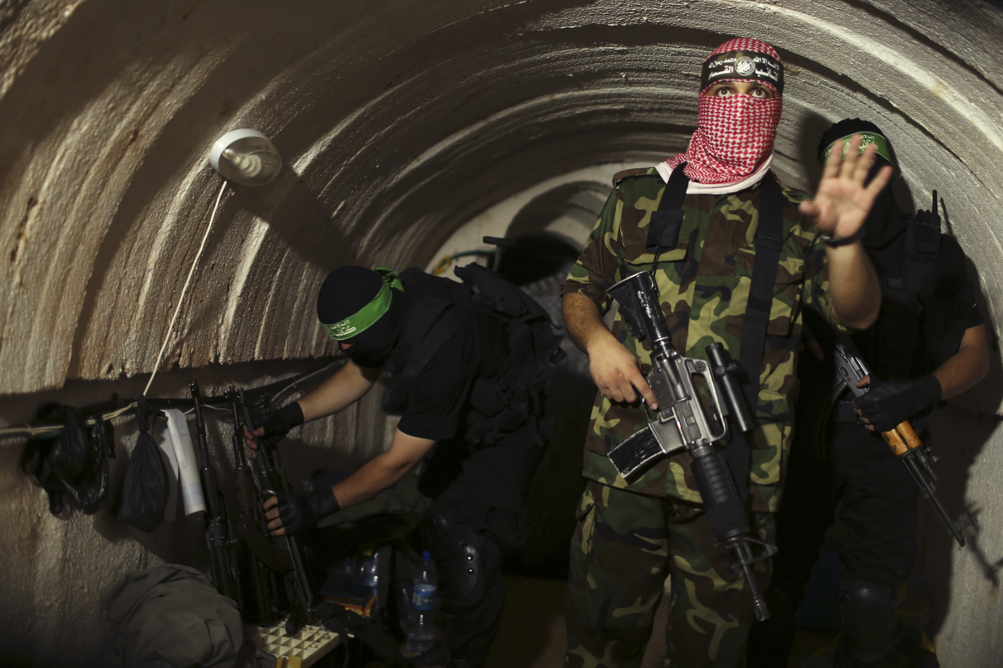 A Palestinian fighter from the Izz el-Deen al-Qassam Brigades, the armed wing of the Hamas movement, gestures inside an underground tunnel in Gaza Aug, 18, 2014. (Mohammed Salem—Reuters)