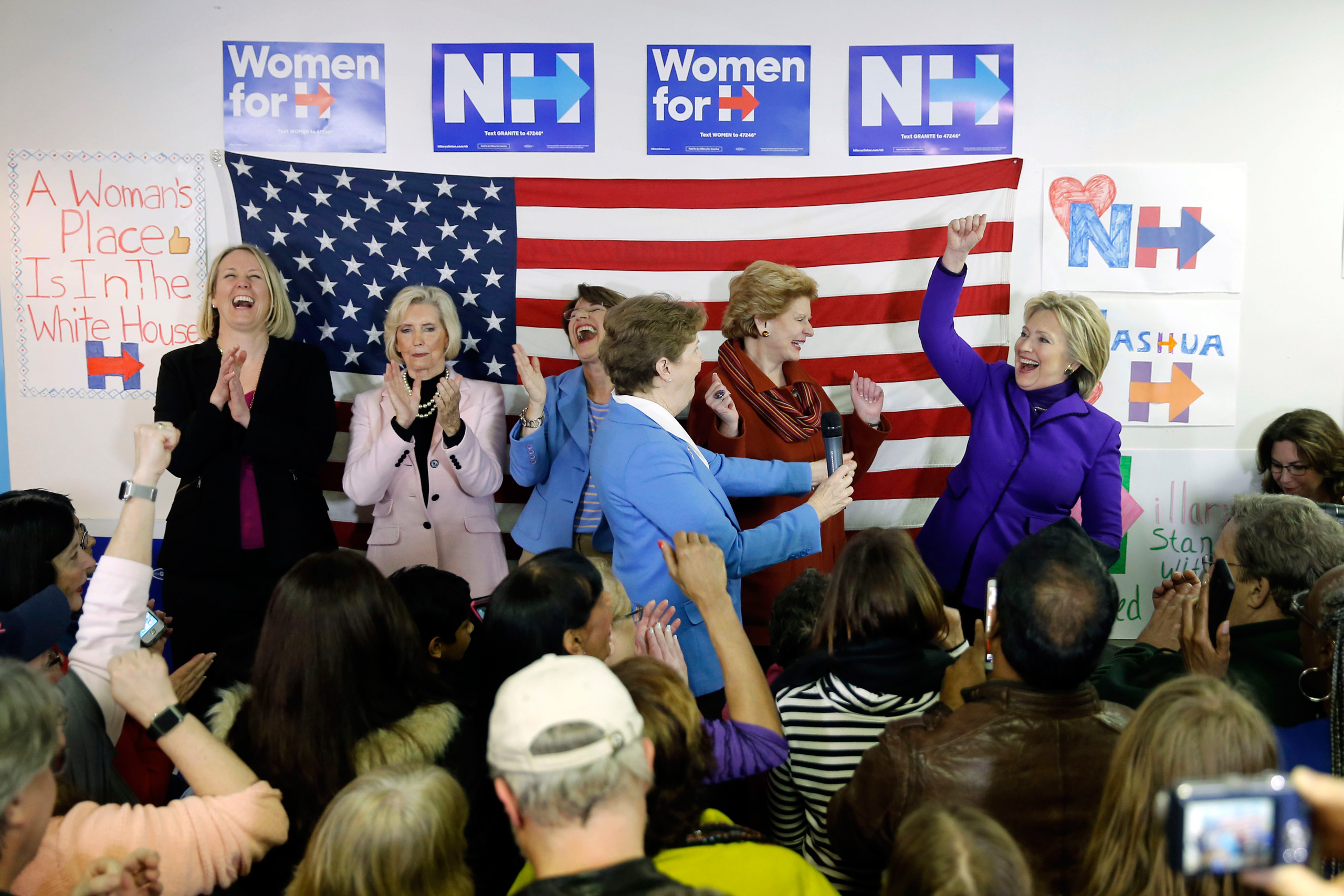 Hillary Clinton is joined on stage by EMILY's List President Stephanie Schriock, left, Lily Ledbetter, Sen. Amy Klobuchar, D-Minn., Jeanne Shaheen, D-N.H., and Sen. Debbie Stabenow, D-Mich., during a visit to a campaign office in Nashua, N.H., on Feb. 5, 2016. (Matt Rourke—AP)