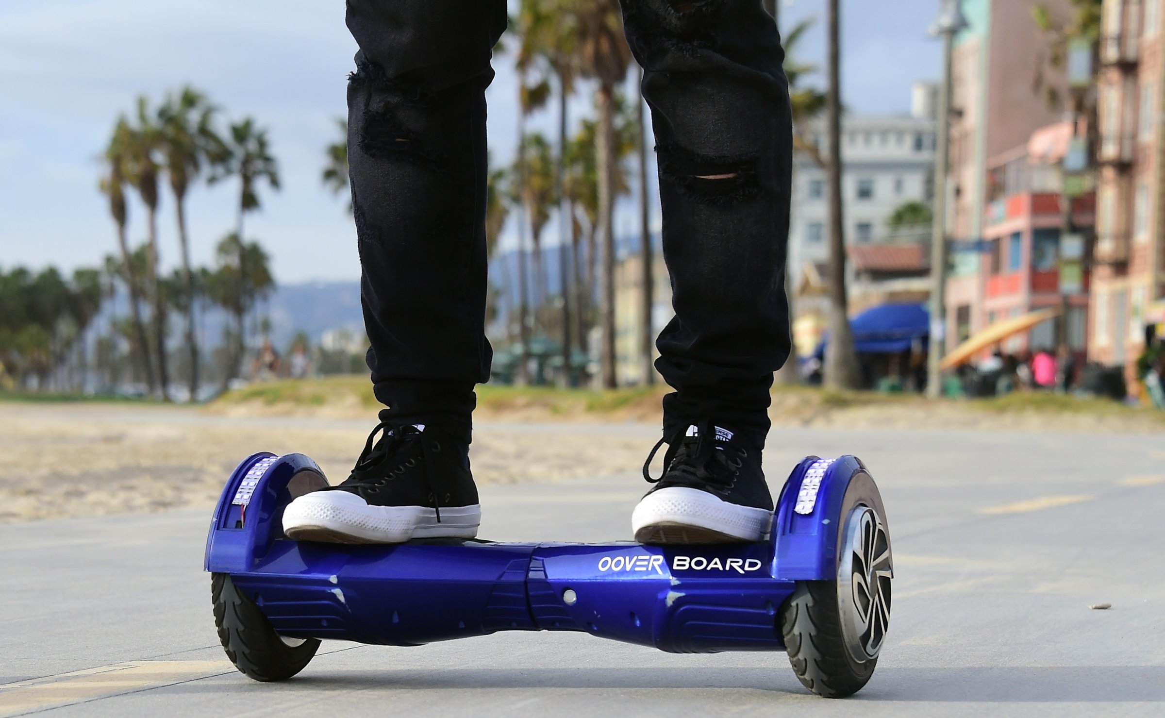 Michael Tran uses his hoverboard on the Venice Beach Boardwalk on December 10, 2015.