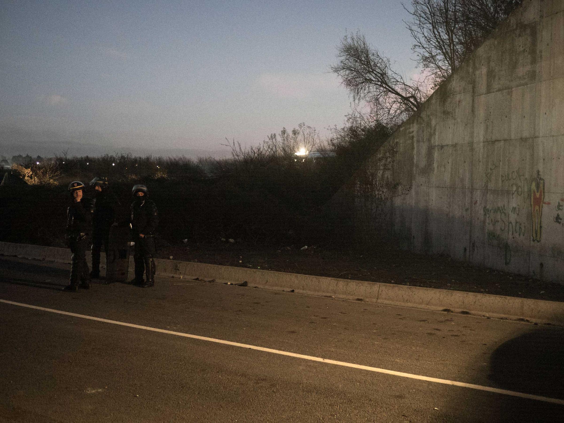 Anti-riot police (CRS) during a tense face-off with a group of migrants. As it has become harder for migrants to cross to the United Kingdom, confrontations with police have become more frequent, Nov. 25, 2015, Calais, France.
