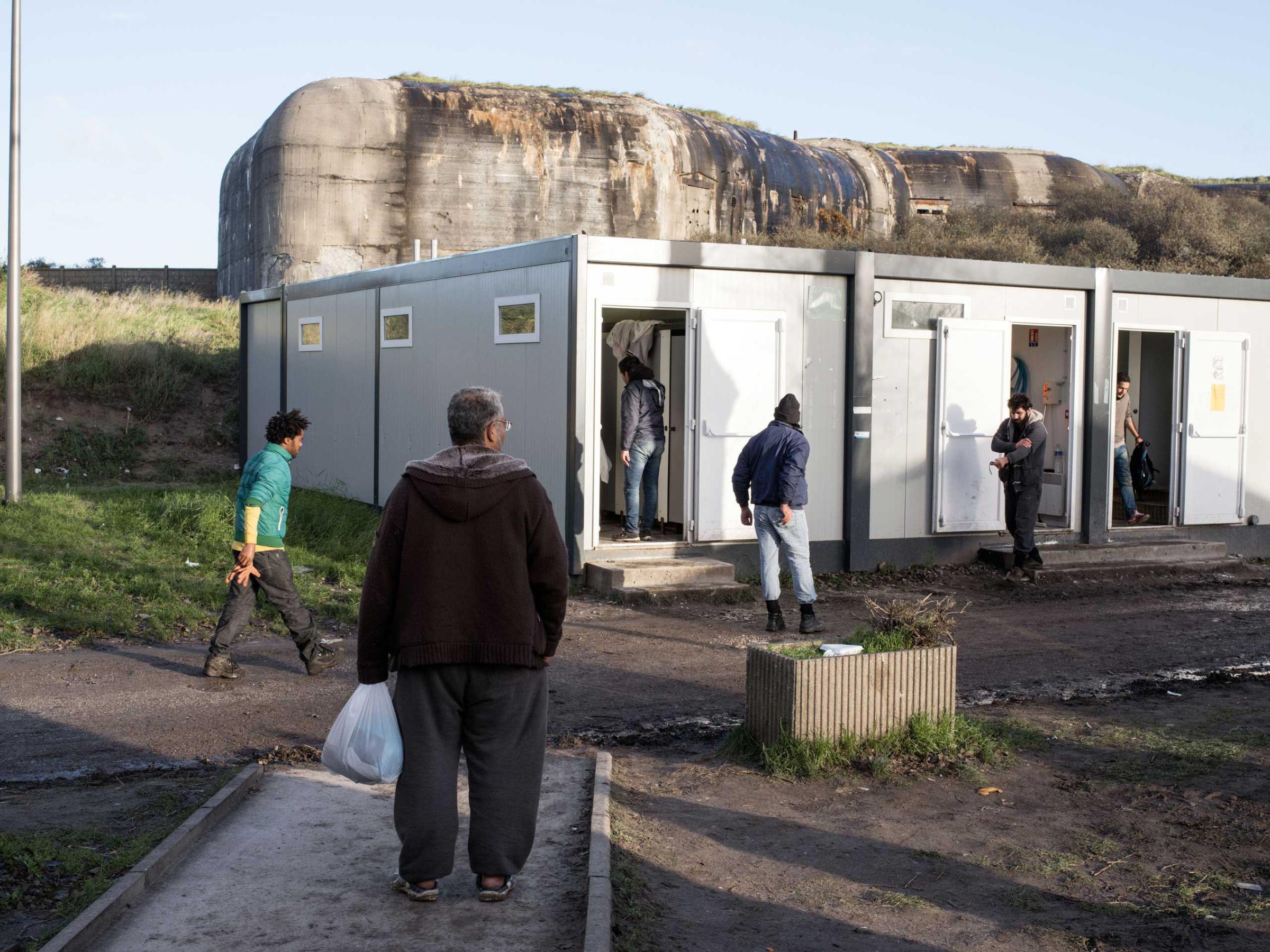 Facilities, including showers and mobile phone rechargers, are available to migrants during the day at the Jules Ferry Center in Calais, France, Nov. 25, 2015.
