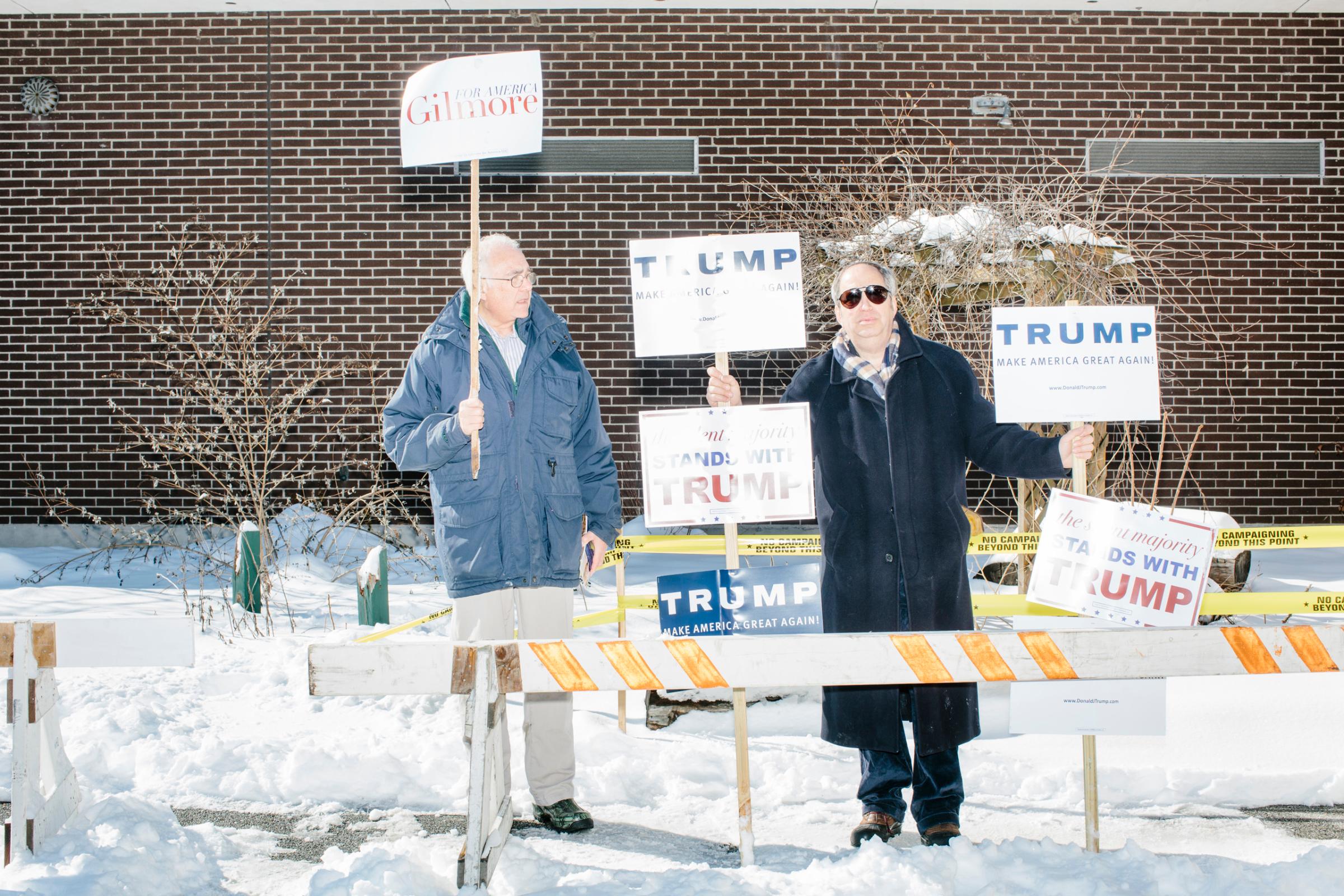 Lloyd Gatling, (left) of Suffolk, Virginia, brother-in-law of former Virginia governor and Republican presidential candidate Jim Gilmore holds campaign signs for the candidate outside the polling location for Manchester Ward 2 at Hillside Middle School in Manchester, New Hampshire, on the day of primary voting, Feb. 9, 2016. Also pictured is Jack Cohen, of Manchester, New Hampshire, a volunteer with the Trump campaign. Gilmore finished in last place among major Republican candidates still in the race with a total of 150 votes.