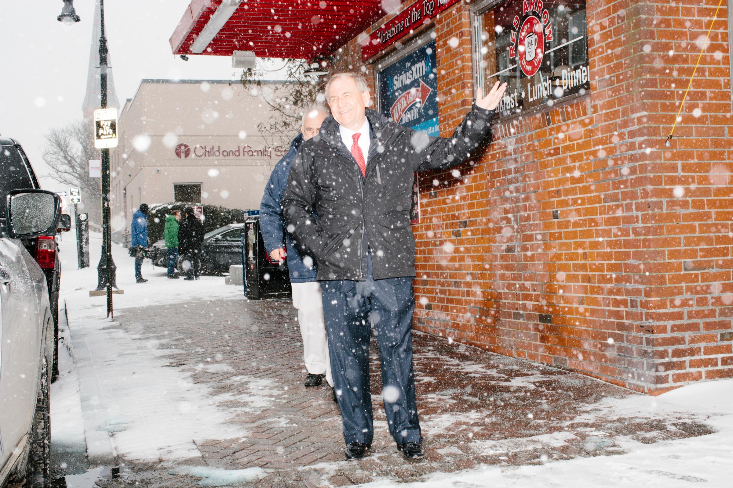 Former Virginia governor and Republican presidential candidate Jim Gilmore walks through the snow with brother-in-law Lloyd Gatling, of Suffolk, Virginia, after visit the Red Arrow Diner in Manchester, New Hampshire, on Mon., Feb. 8, 2016. The Red Arrow Diner is a frequent stop of political candidates. Sirius XM was broadcasting live from the diner Monday and Tuesday. Gilmore finished in last place among major Republican candidates still in the race with a total of 150 votes.