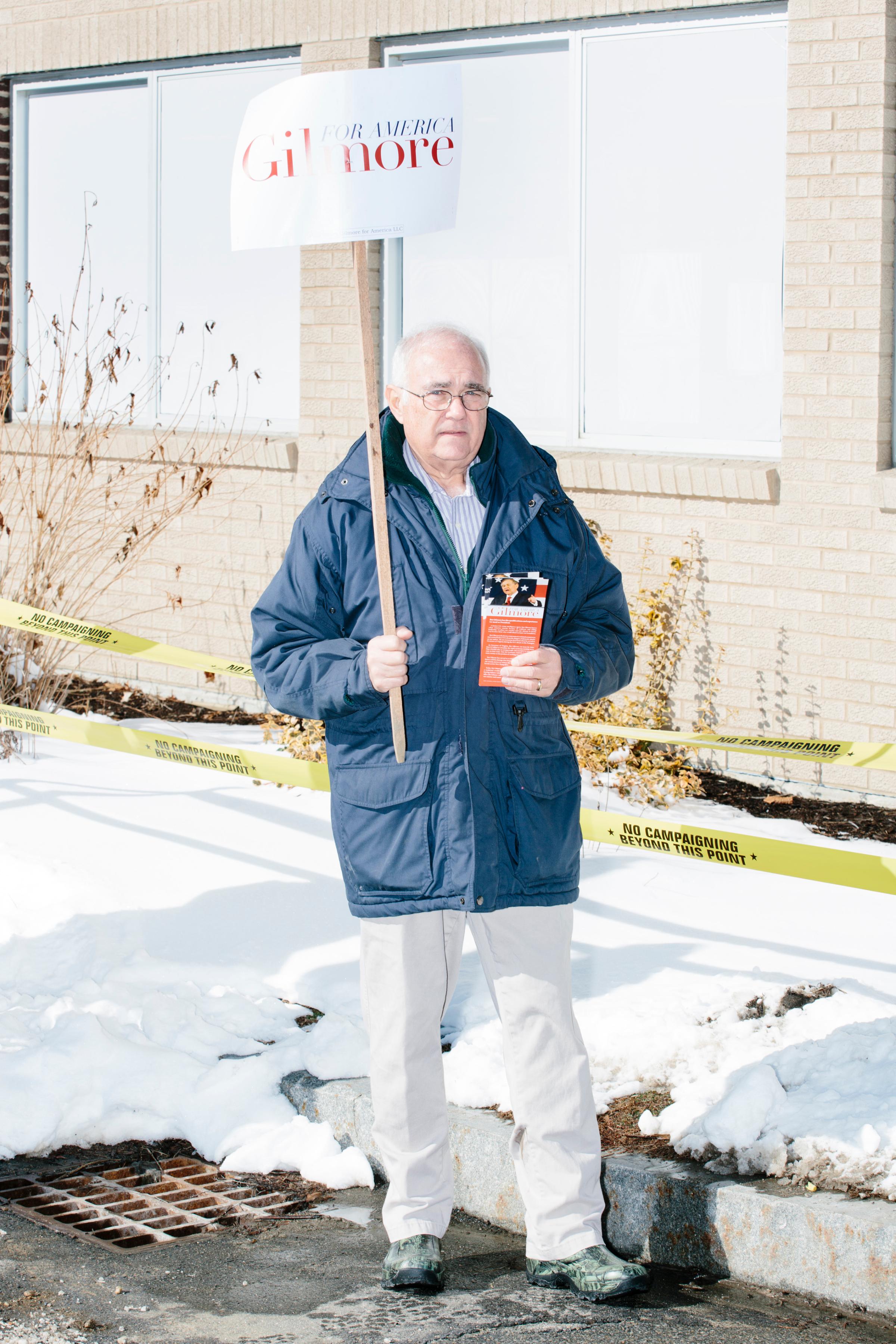 Lloyd Gatling, of Suffolk, Virginia, brother-in-law of former Virginia governor and Republican presidential candidate Jim Gilmore holds campaign signs for the candidate outside the polling location for Manchester Ward 2 at Hillside Middle School in Manchester, New Hampshire, on the day of primary voting, Feb. 9, 2016. Gilmore finished in last place among major Republican candidates still in the race with a total of 150 votes.