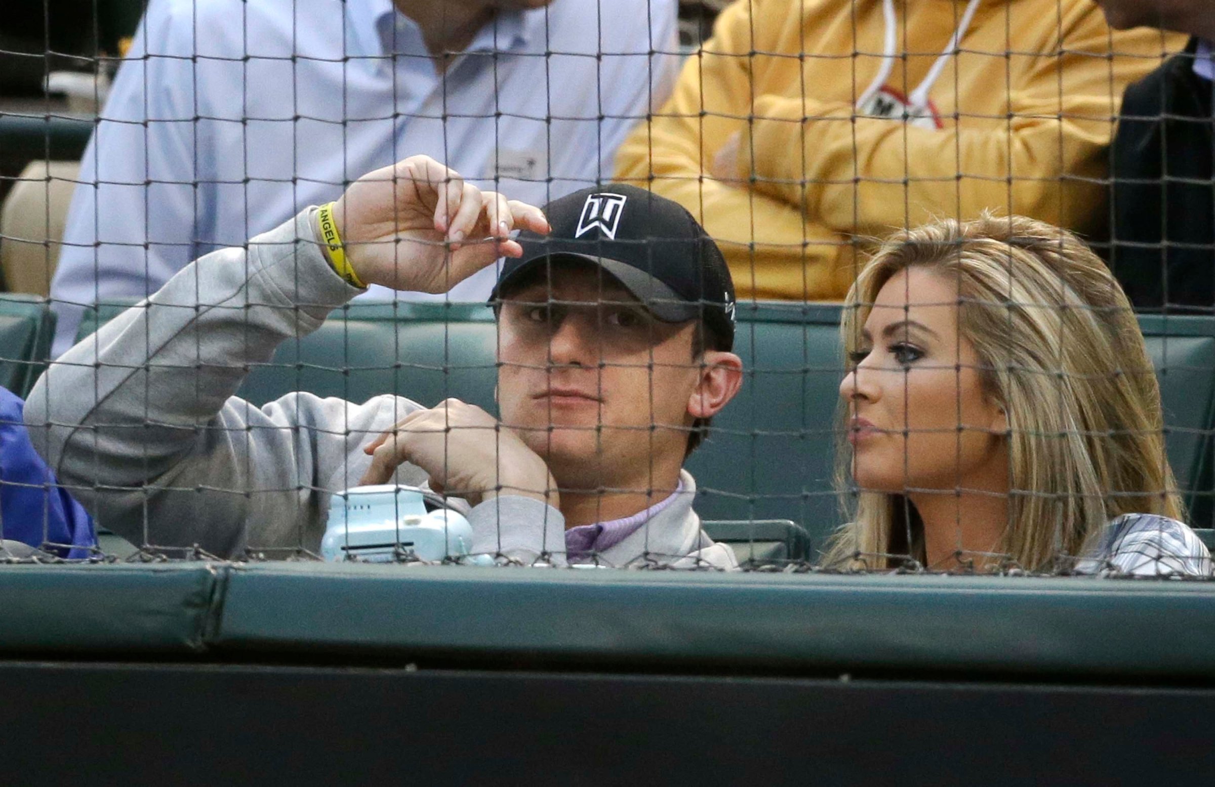 Johnny Manziel sits with Colleen Crowley during a baseball game between the Los Angeles Angels and the Texas Rangers in Arlington, Texas on April 14, 2015.