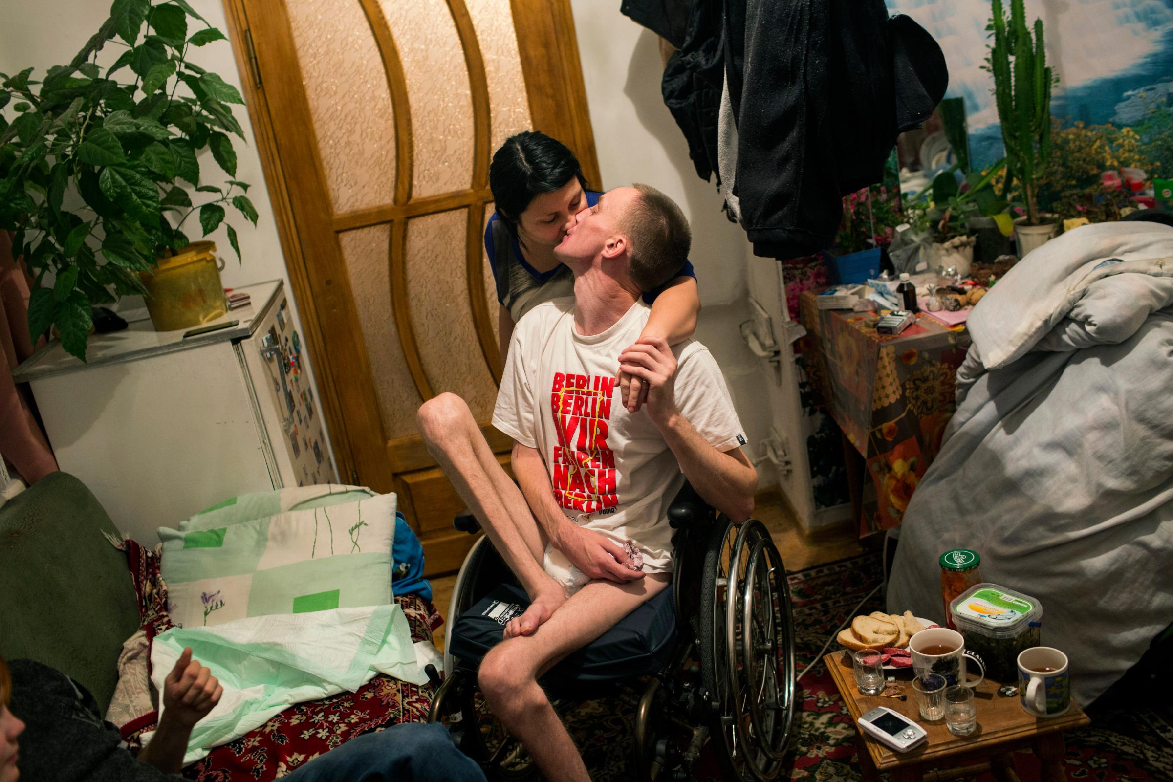 Honcharovsky kisses his wife, Oksana Khivchuk, in their home in Teofipol, Ukraine, Nov. 17, 2014. "Life for us is very difficult at the moment," said Khivchuk. "We hoped that he would slowly begin to walk again, but as you see, there have been no changes."