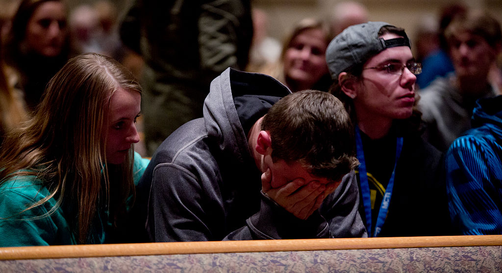 People gather and pray at Center Point Church following a mass shooting on February 21, 2016 in Kalamazoo, Michigan.