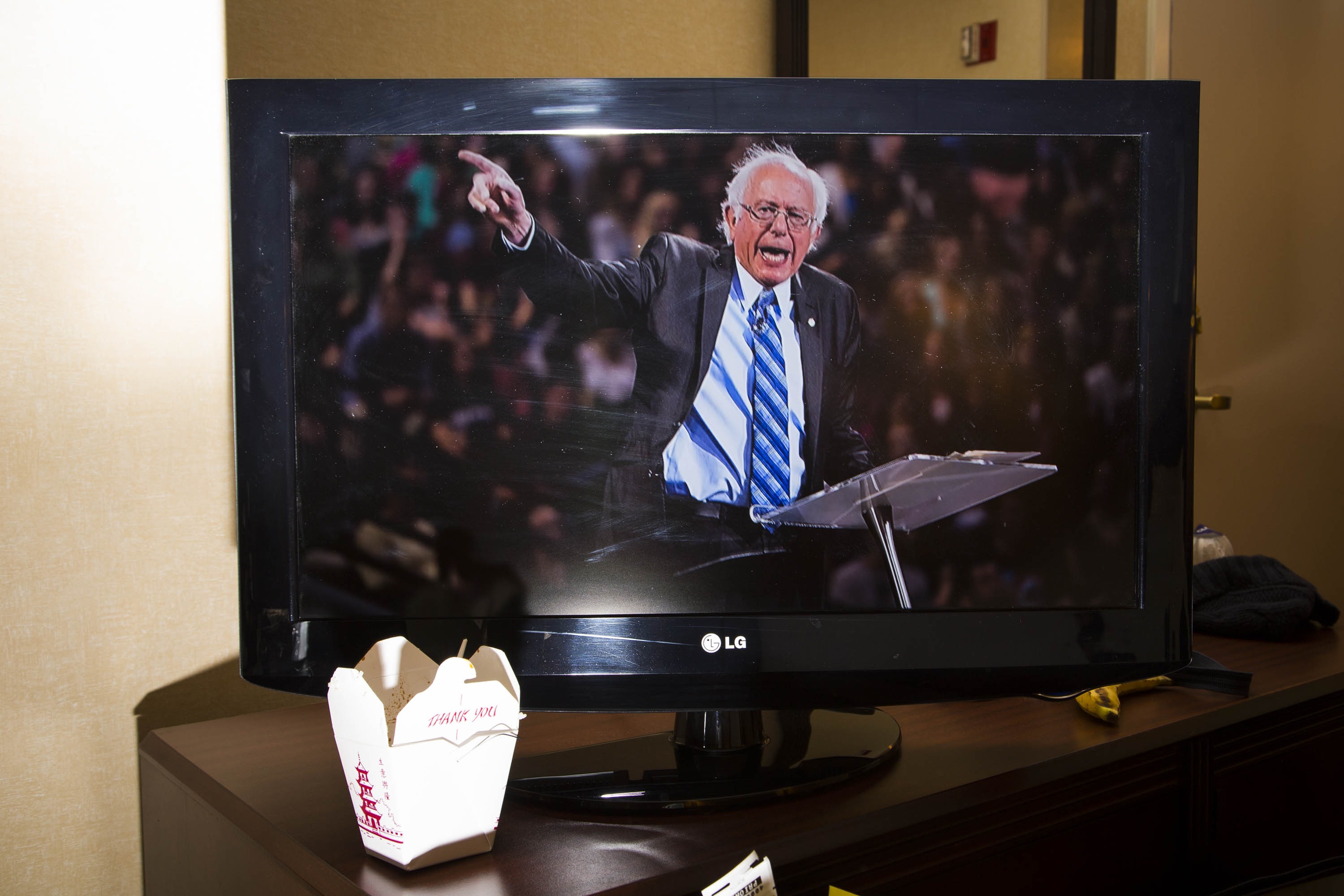 A television screen displays Democratic presidential candidate, Vermont Sen. Bernie Sanders in a New Hampshire hotel.