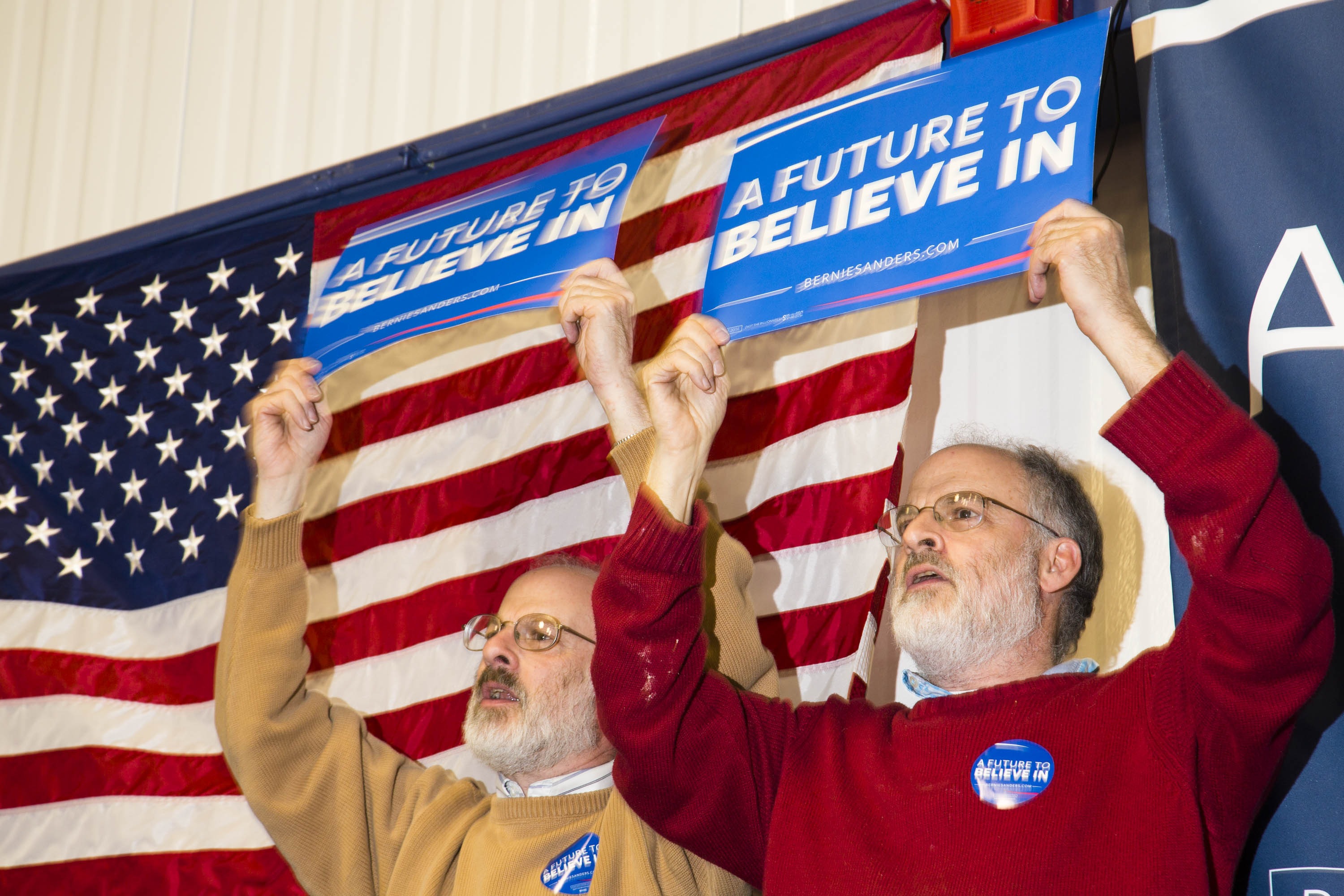 Twins Larry, left, and Bruce Gordon cheer for Democratic presidential candidate, Vermont Sen. Bernie Sanders during a campaign event at Great Bay Community College on Feb. 7, 2016, in Portsmouth, N.H.