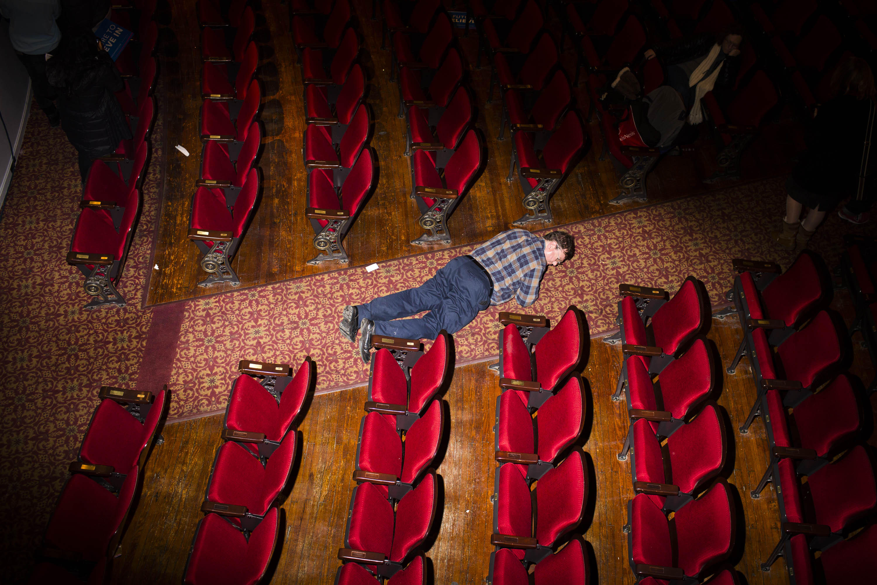 A man looks for something he dropped at the Palace Theater, where Democratic presidential candidate, Vermont Sen. Bernie Sanders held a campaign event on  Feb. 8, 2016, in Manchester, N.H.