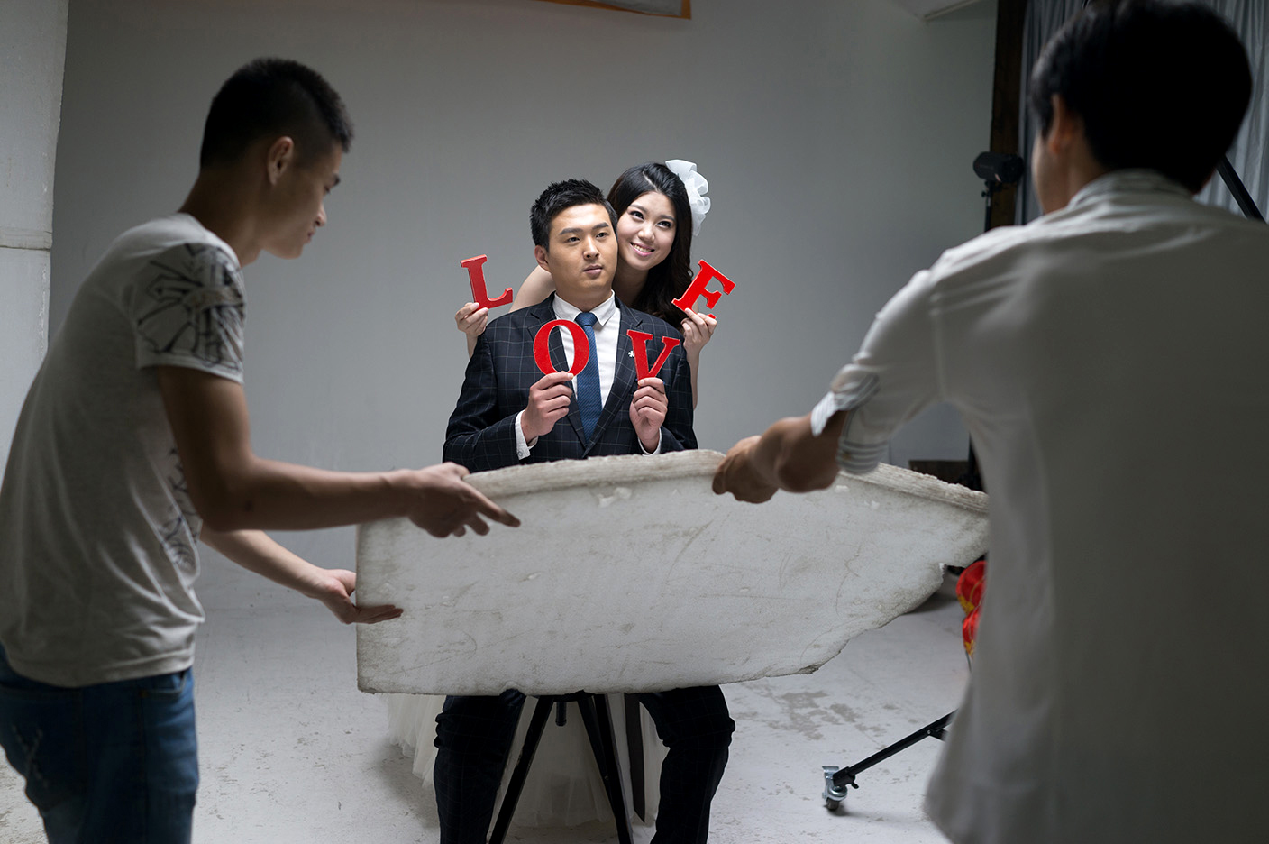 A couple is photographed at Inside Only Photo Studio on the outskirts of Shanghai in June 2013. The studio houses three floors of sets for wedding photos, including rooms of dresses and suits.