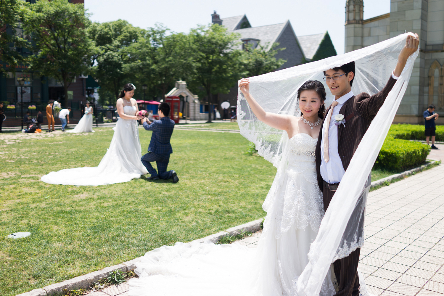 A young couple poses in front of the church, a popular backdrop for wedding photos.