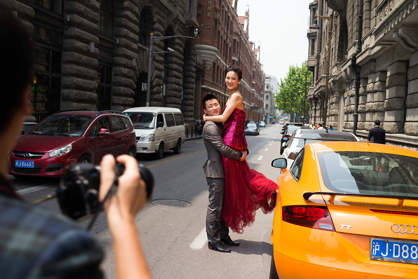 A couple is photographer on the streets of the Bund in Shanghai.