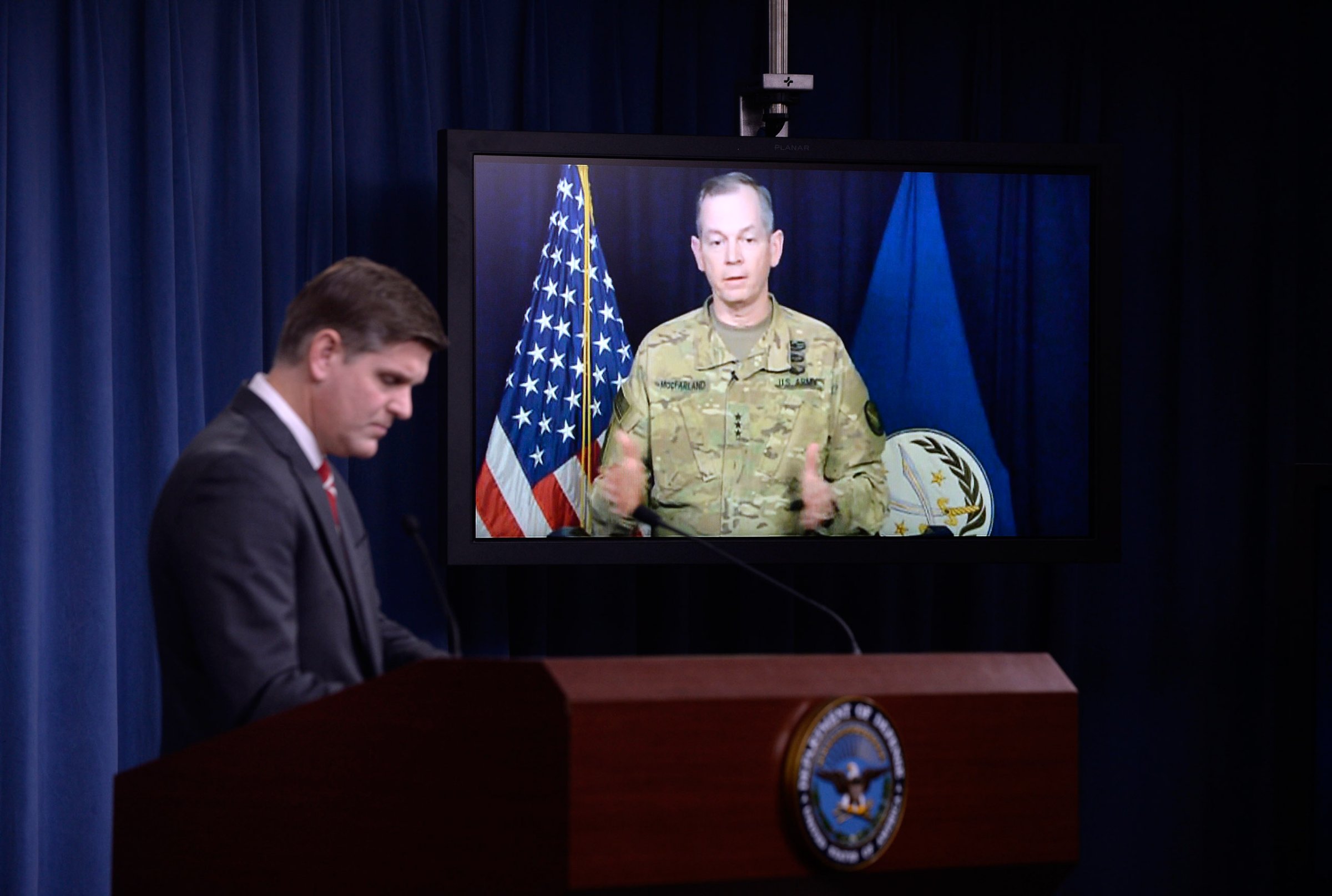 ARLINGTON, VA - FEBRUARY 1: Combined Joint Task Force Commander Army Lt. Gen. Sean MacFarland speaks via teleconference from Baghdad, Iraq as Pentagon Press Secretary Peter Cook listens during a media briefing at the Pentagon to update operations on Operation Inherent Resolve on February 1, 2016 in Arlington, Virginia. It was reported that U.S. and coalition military forces have continued to attack Islamic State of Iraq and the Levant terrorists in Syria and Iraq as part of Operation Inherent Resolve. (Photo by Olivier Douliery/Getty Images)