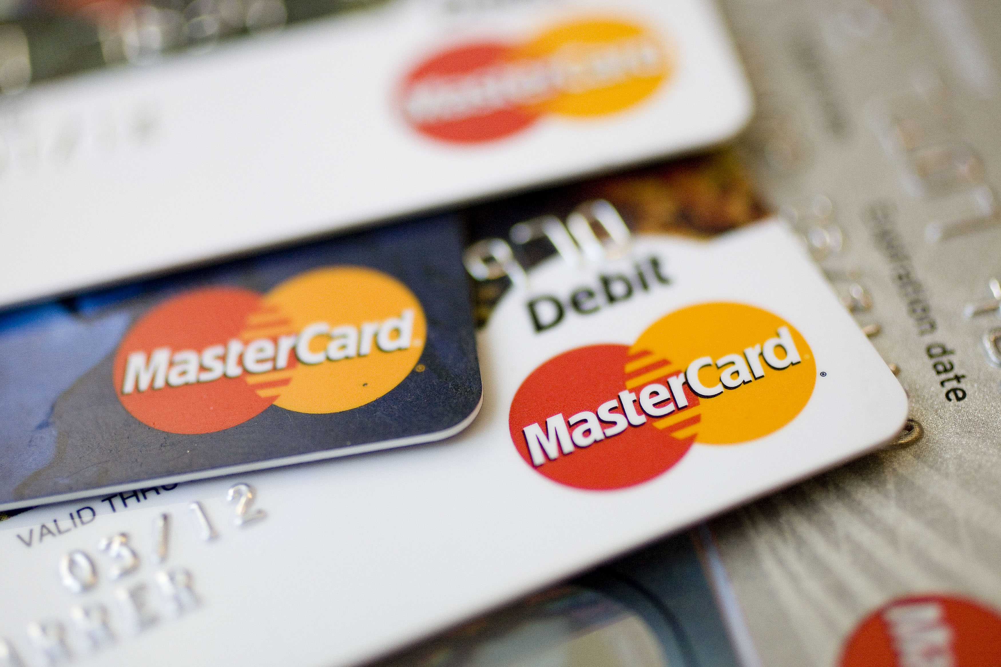 MasterCard logos appear on credit and debit cards arranged f