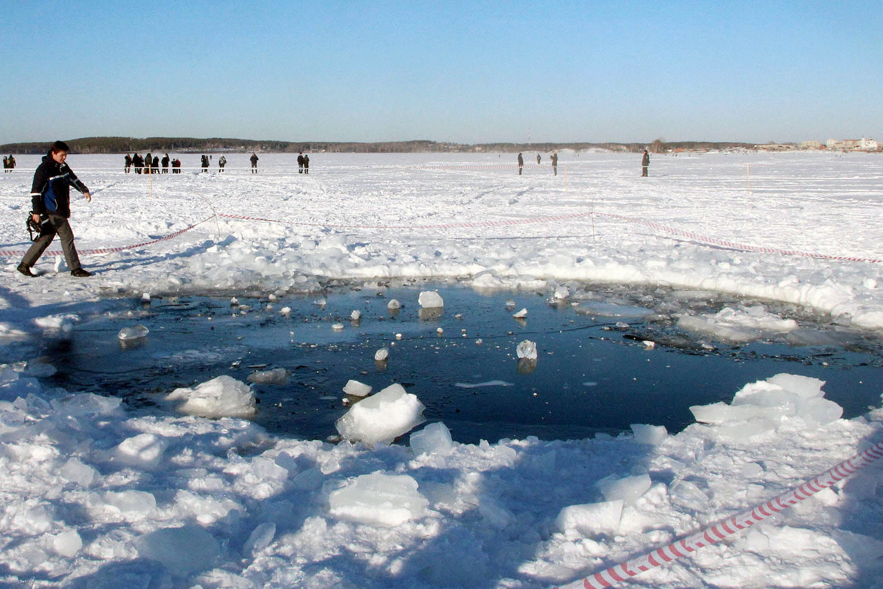 A hole on the ice of Chebarkul Lake in the Russian region of Chelyabinsk, believed to have been made by a meteor fragment, is shown on Feb. 16, 2013. (Kyodo/AP)