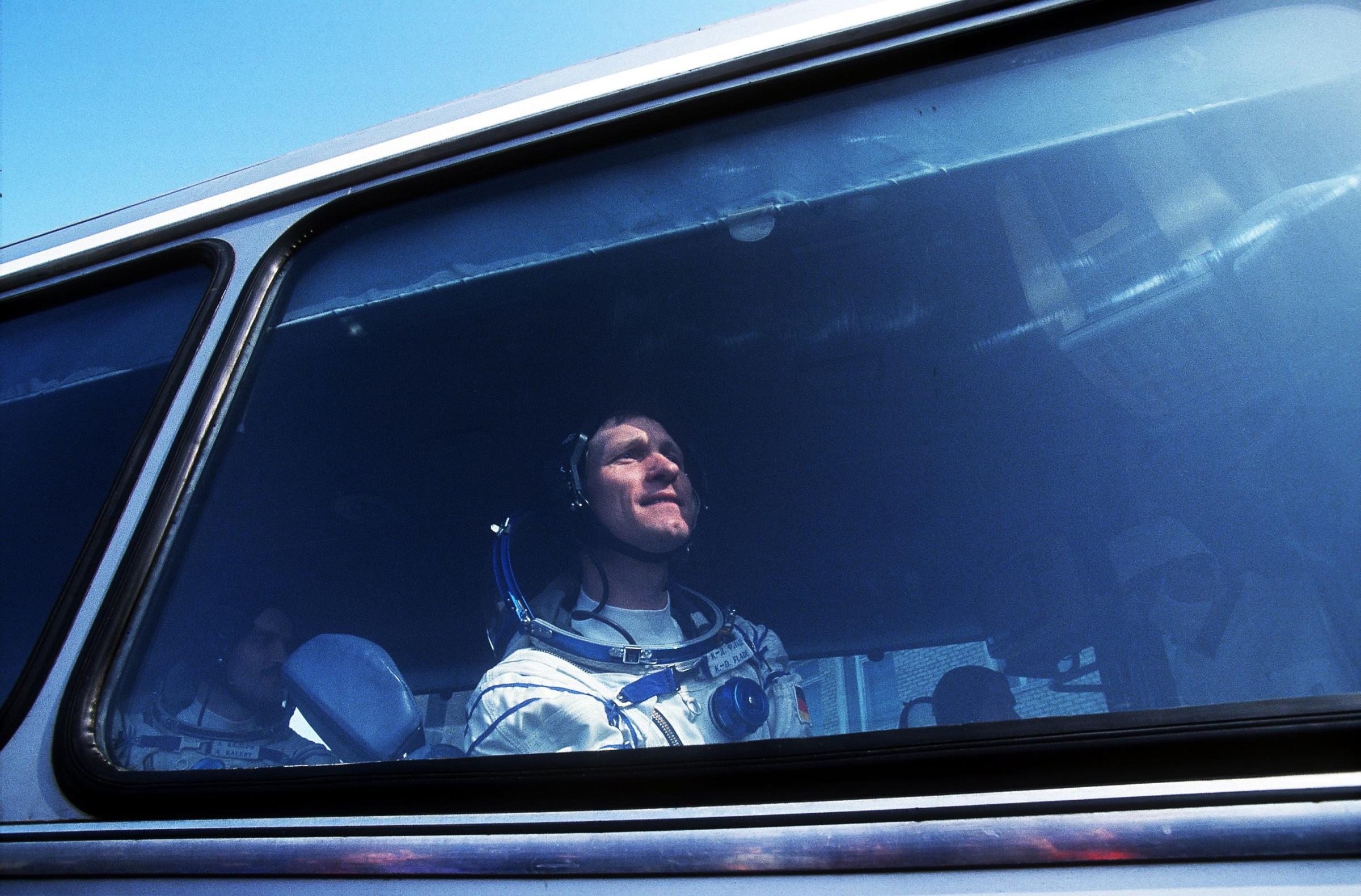 German astronaut Klaus Dietrich Flade looks out of the window of a bus that brings him and Russian cosmonauts to the spacecraft that will take them to the Mir space station, on March 17, 1992, in Baikonur, Kazakhstan. The Soyuz TM-14 spacecraft left the Baikonur Cosmodrome in Kazakhstan on March 17 and docked at the Kvant rear port of the MIR on March 19, returning to earth after almost 8 days in space, on March 25, 1992. The MIR (Russian word for Peace, World), was a space station operated by the Soviet Union, and later by the Russian Confederation. It was built between 1986 and 1996 and operated for fifteen years until March 23, 2001. It holds the record for the longest continuous presence in space, eight days short of ten years. In its fifteen year lifespan it was occupied for a total of twelve and a half years. The station was made accessible for astronauts and cosmonauts from thirteen different nations.