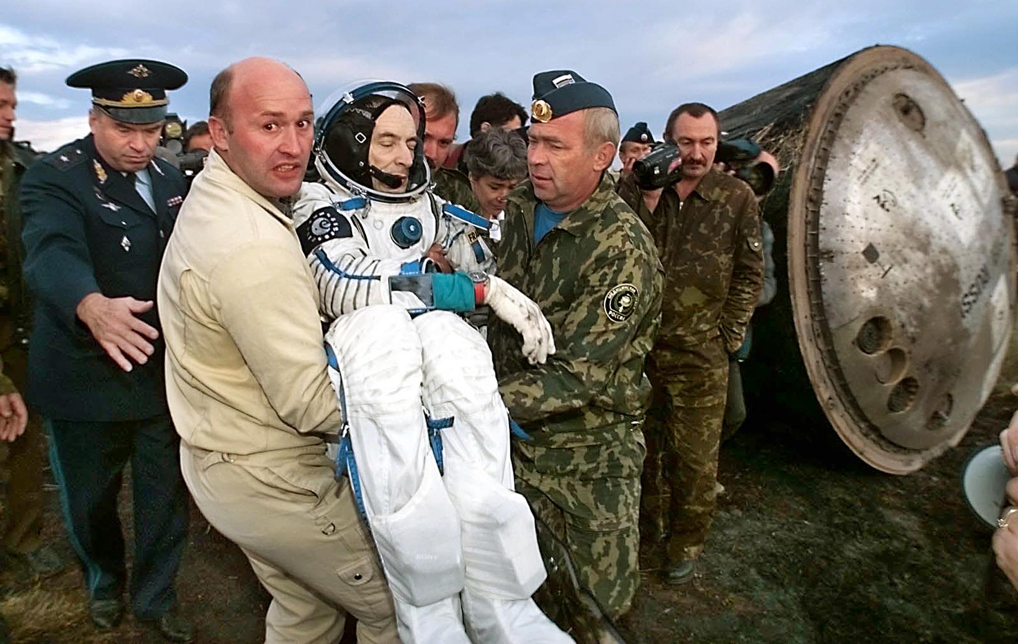 French astronaut Jean-Pierre Haignere, part of the last crew on Mir, is carried out of the  Souyz TM- 29  space craft after landing in Kazakhstan on Aug. 28, 1999.