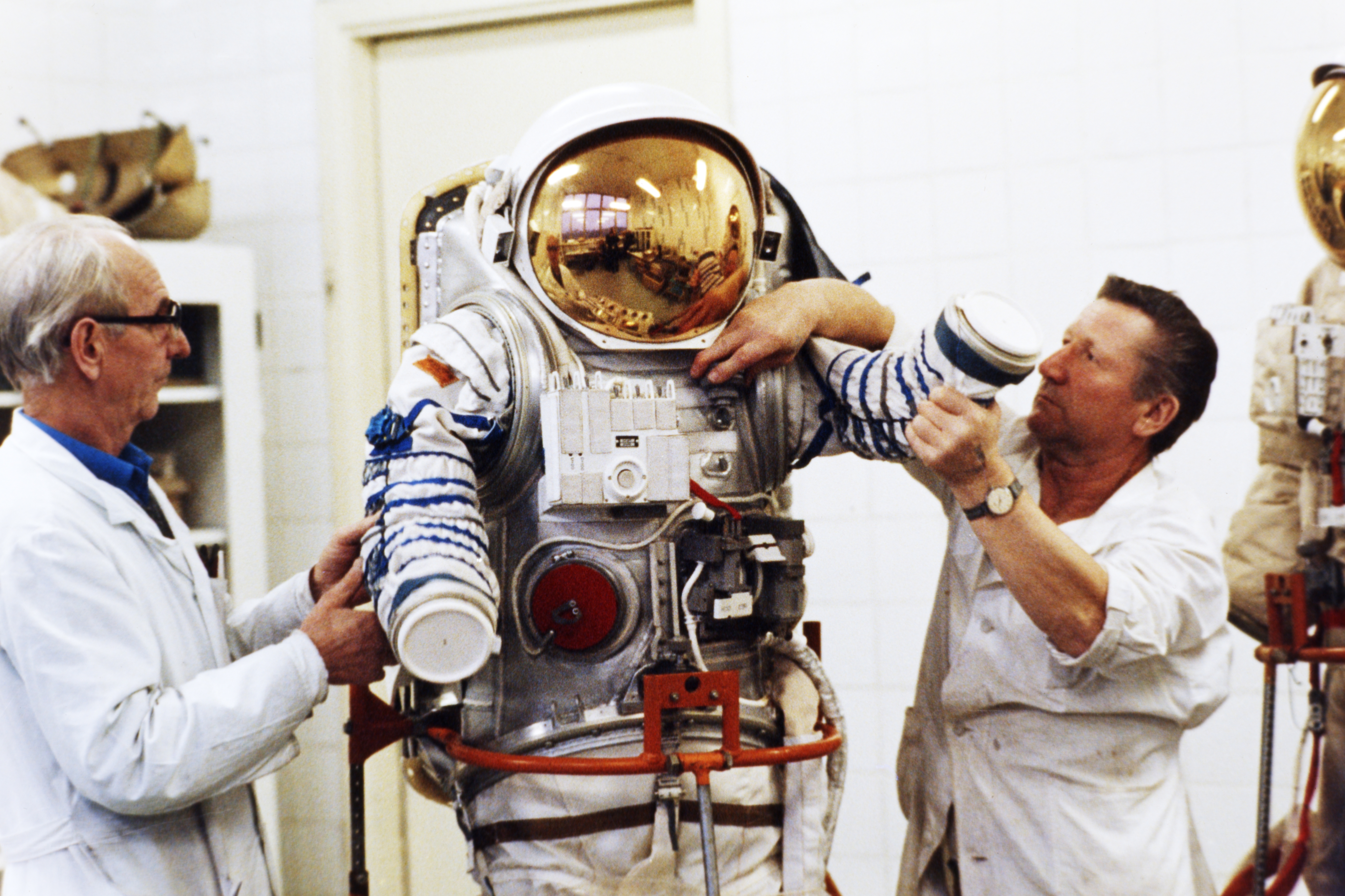 Assemblers, Ivan Volchenkov and Nikolay Petrov, at a de-classified aerospace facility with one of several newly designed spacesuits to be delivered to the mir space station in 1992.