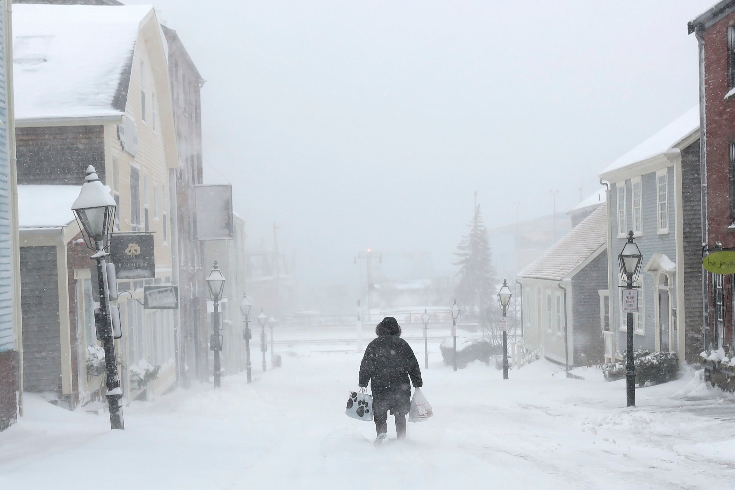 A woman walks down the street during a snowstorm in New Bedford, Mass., on Feb. 8, 2016.