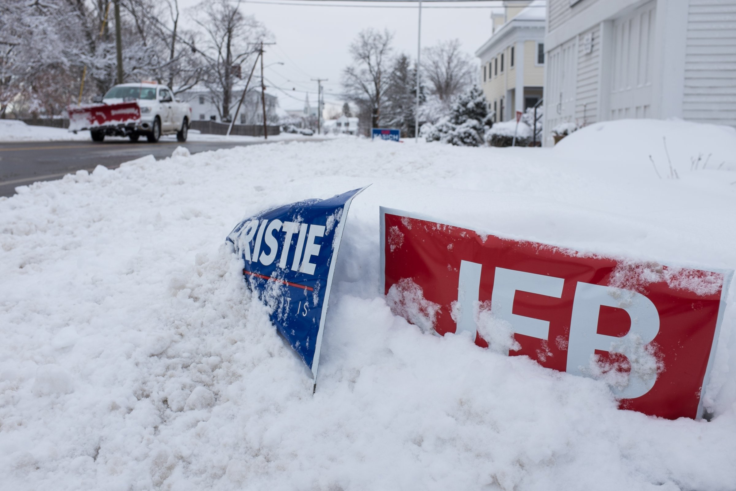 Political signs buried in snow are seen on Feb. 5, 2016 in Hollis, New Hampshire.